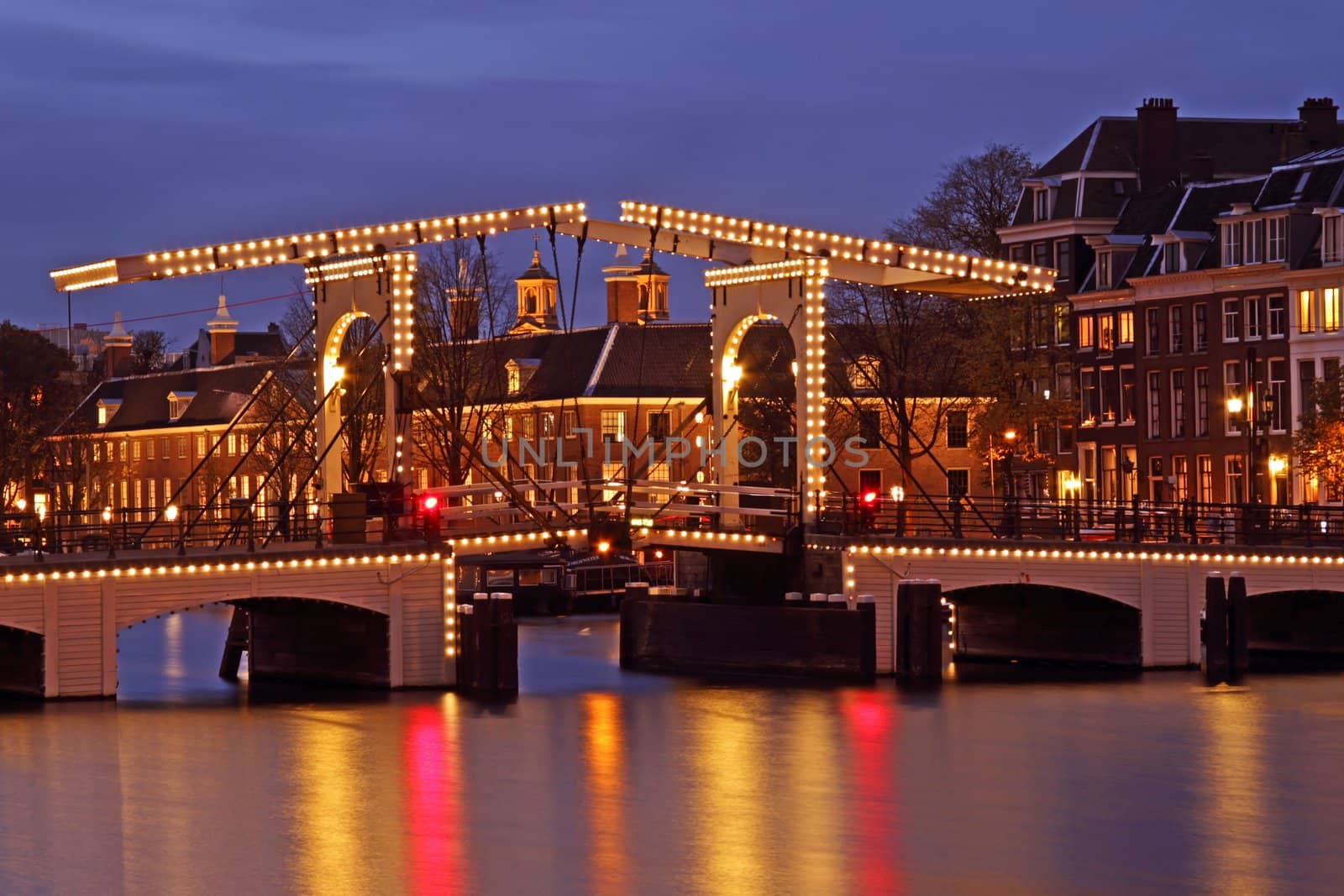 Illuminated Thiny bridge in Amsterdam the Netherlands at twilight