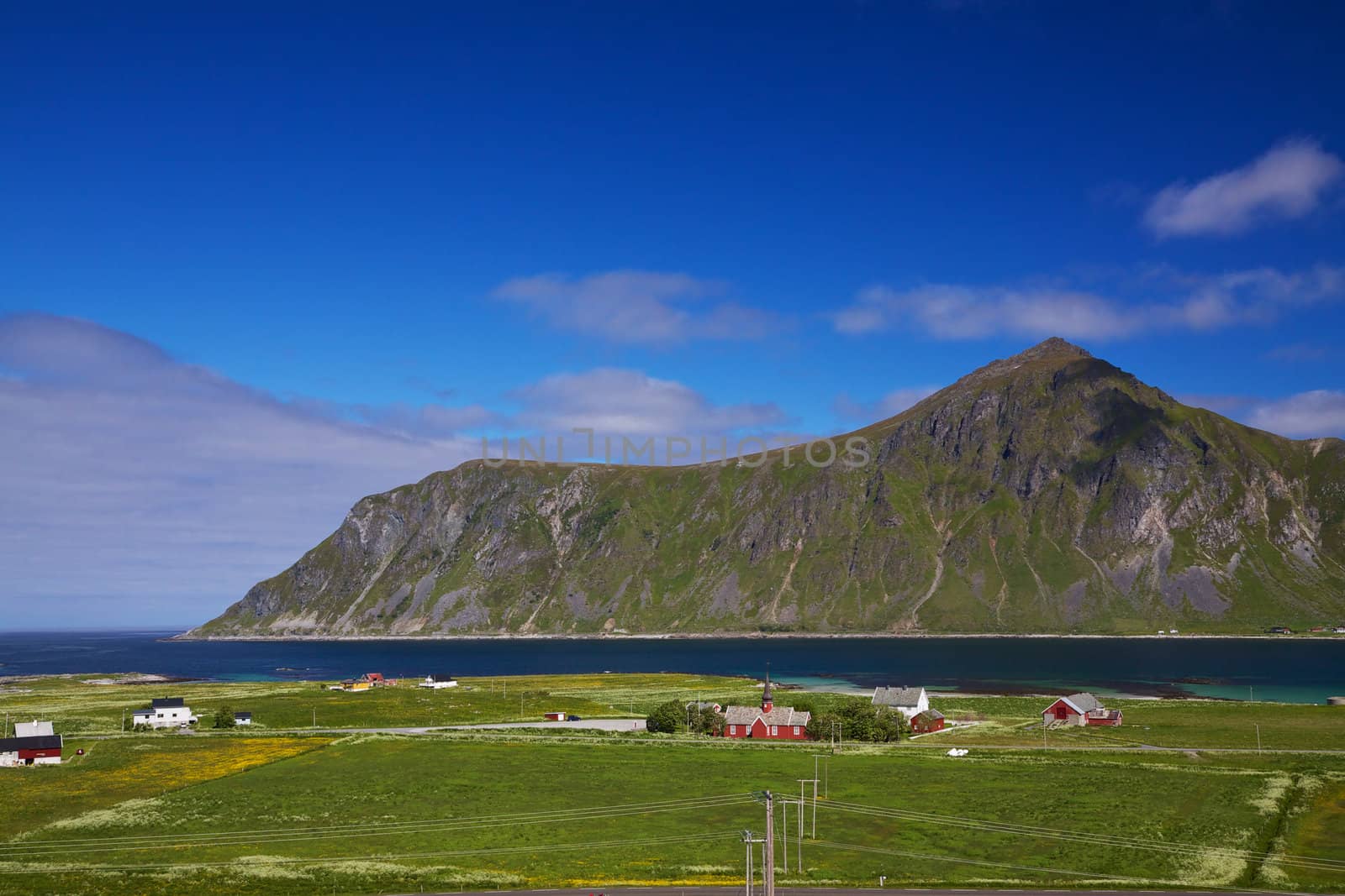 Scenic village of Flakstad with traditional norwegian church on Lofoten islands, Norway