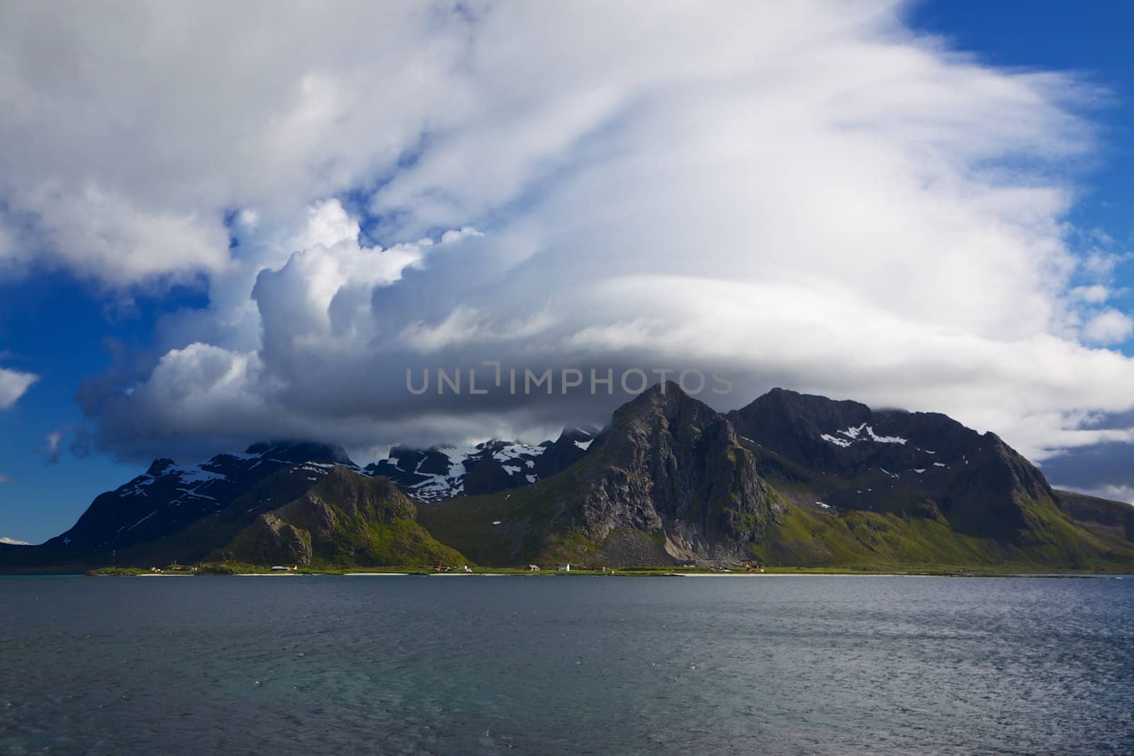 Picturesque mountain peaks towering above fjord on Lofoten islands in Norway