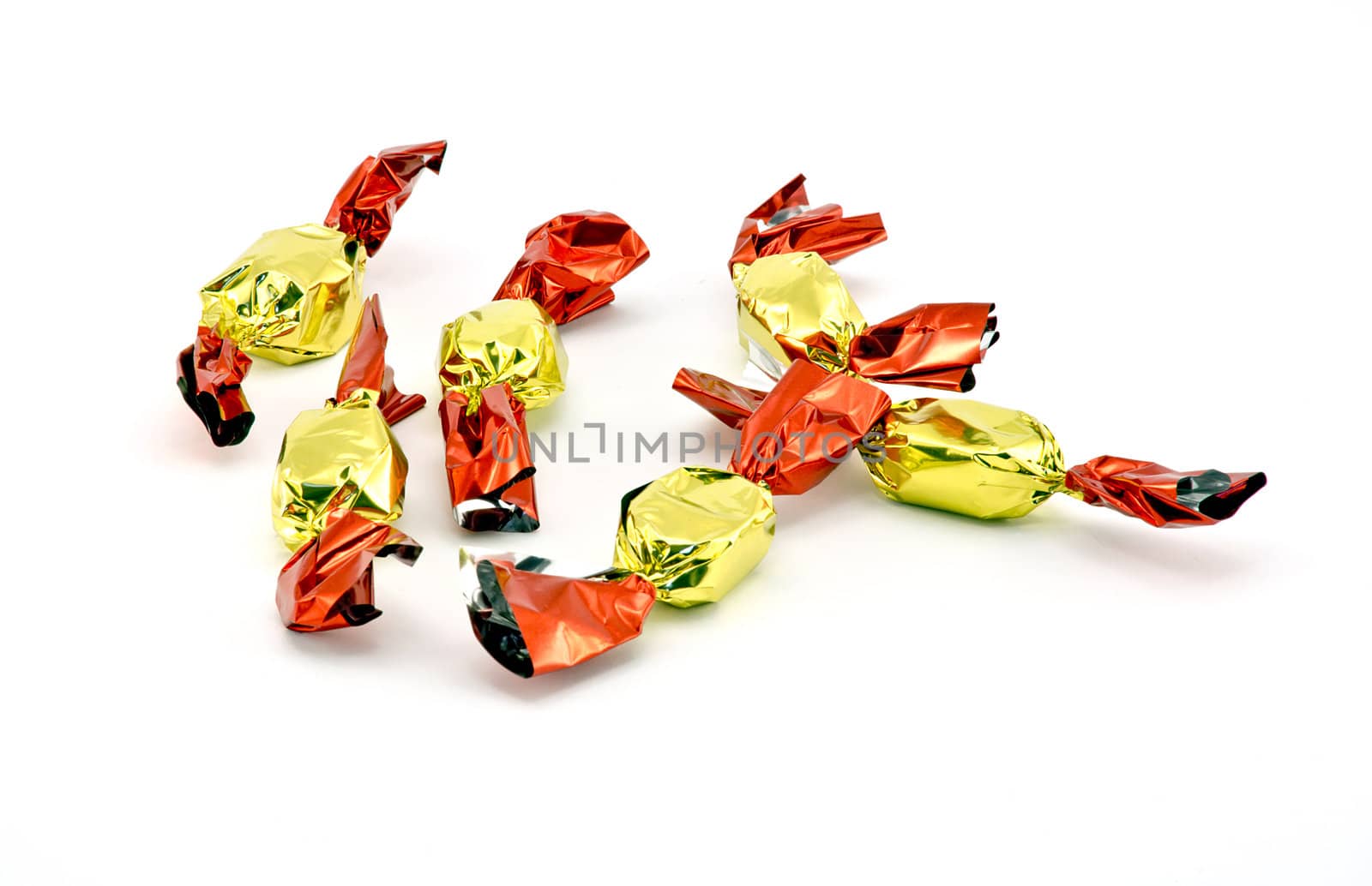 Red and gold christmas pralines on white background
