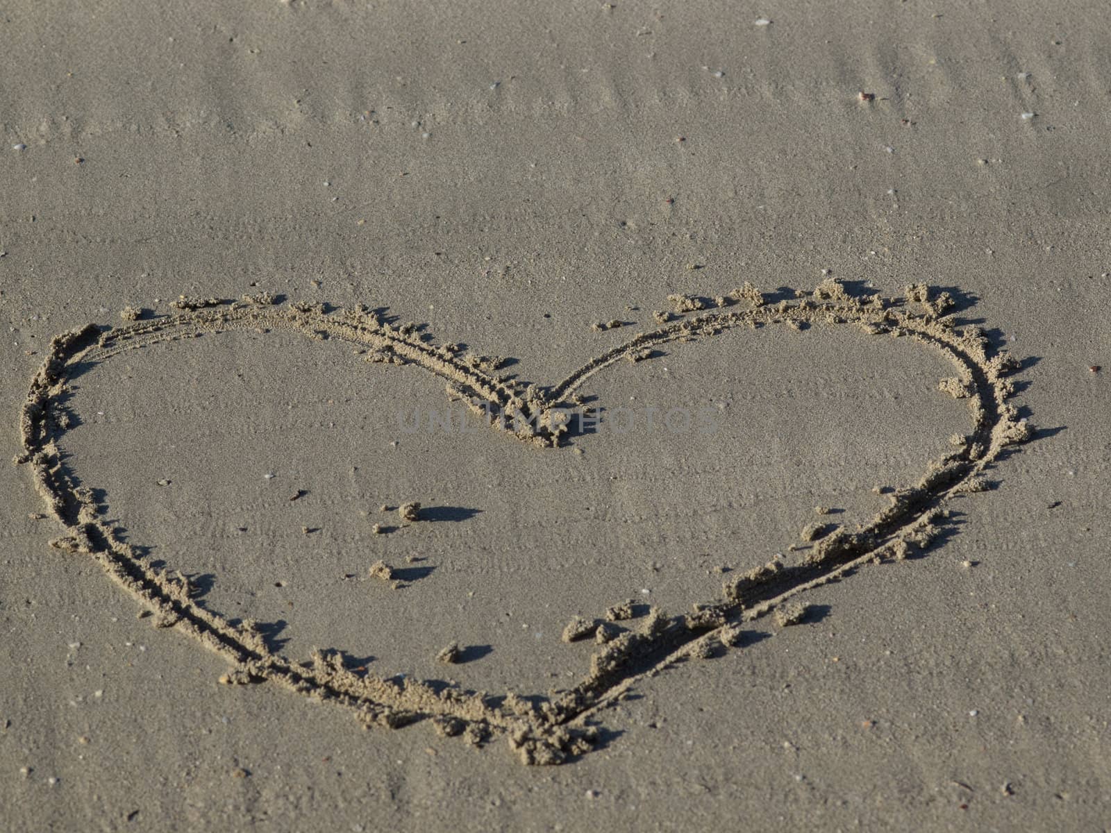 A heart shape drawn in the sand