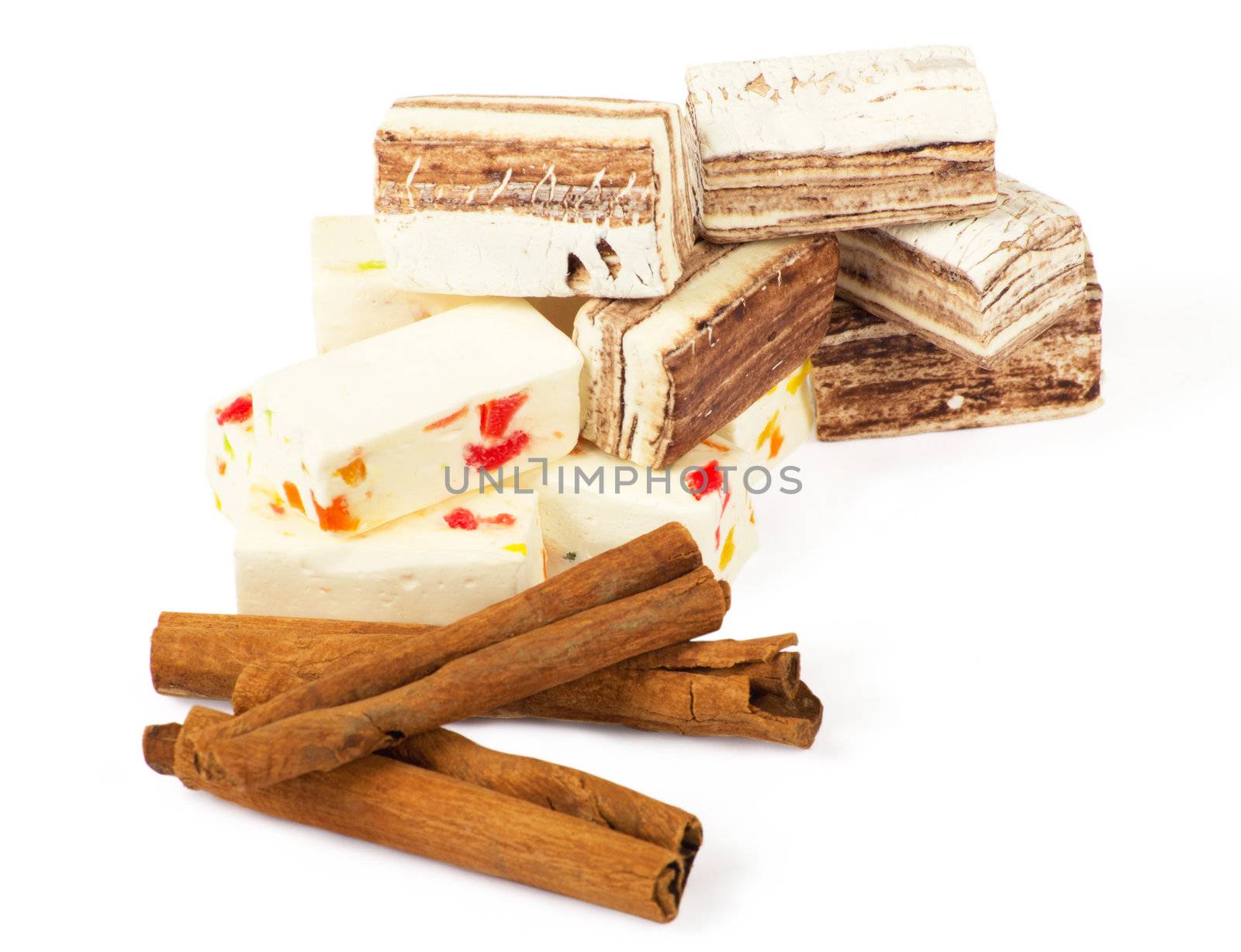 Closeup of sweets and cinnamon over white
