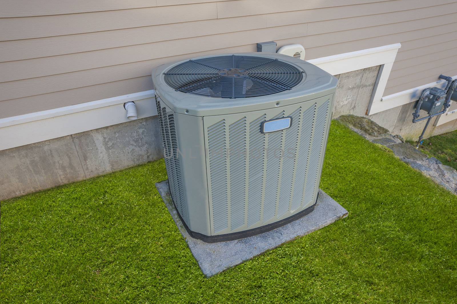 Heating and cooling unit on the side of a residential house
