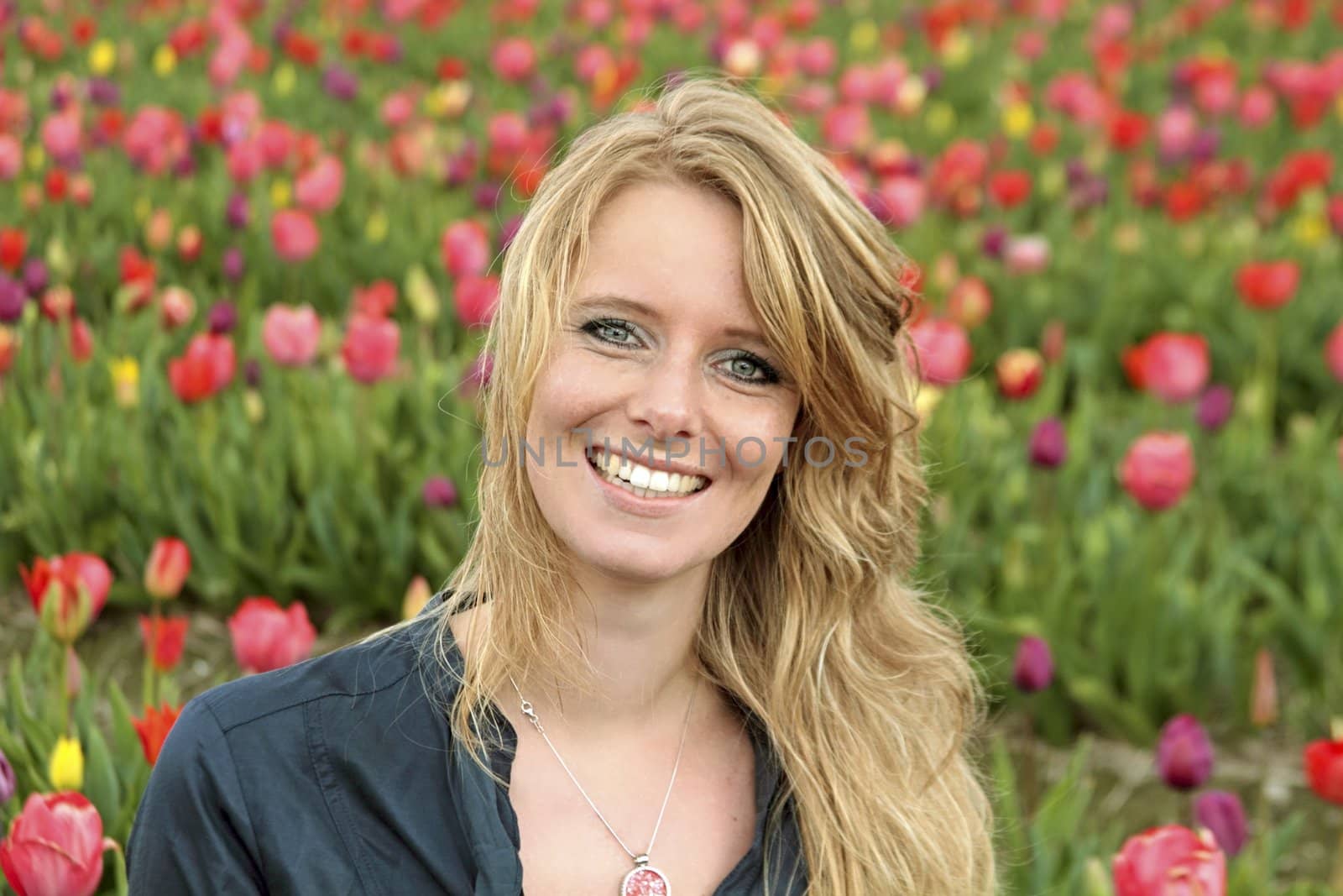 Dutch woman between the flower fields in the Netherlands