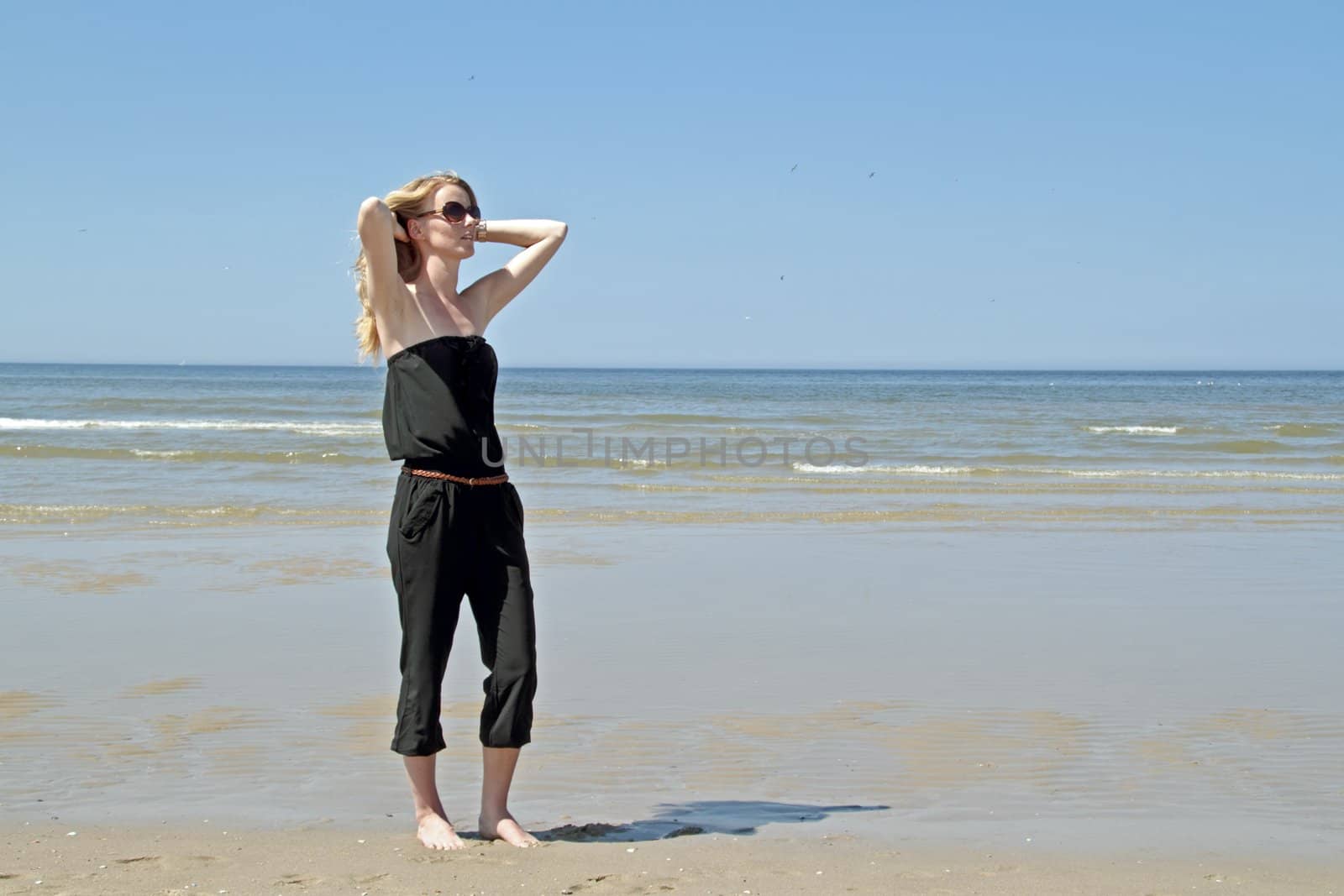 Beautiful woman relaxing at the beach from the north sea in the Netherlands