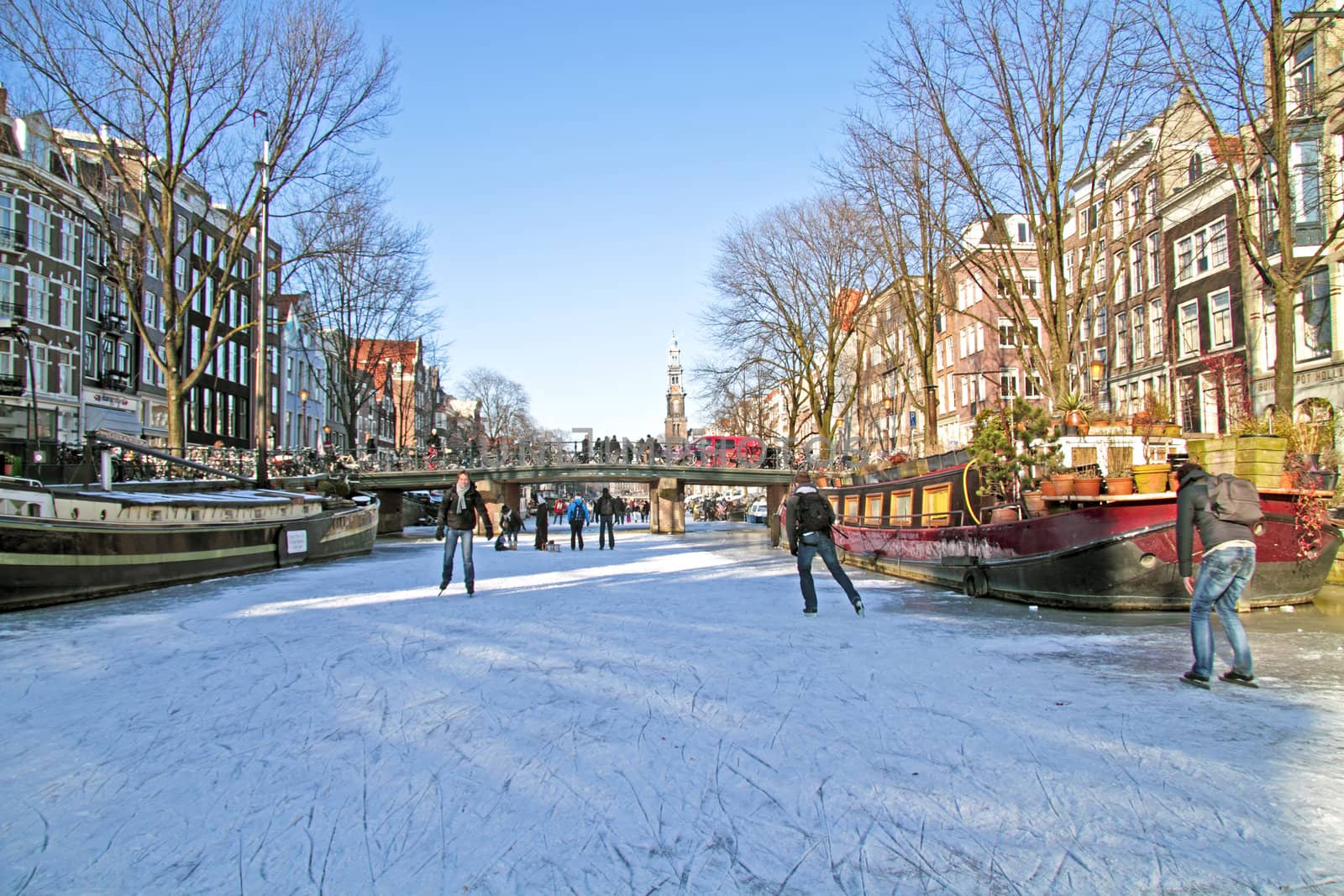 Ice skating on the canals in Amsterdam the Netherlands in winter