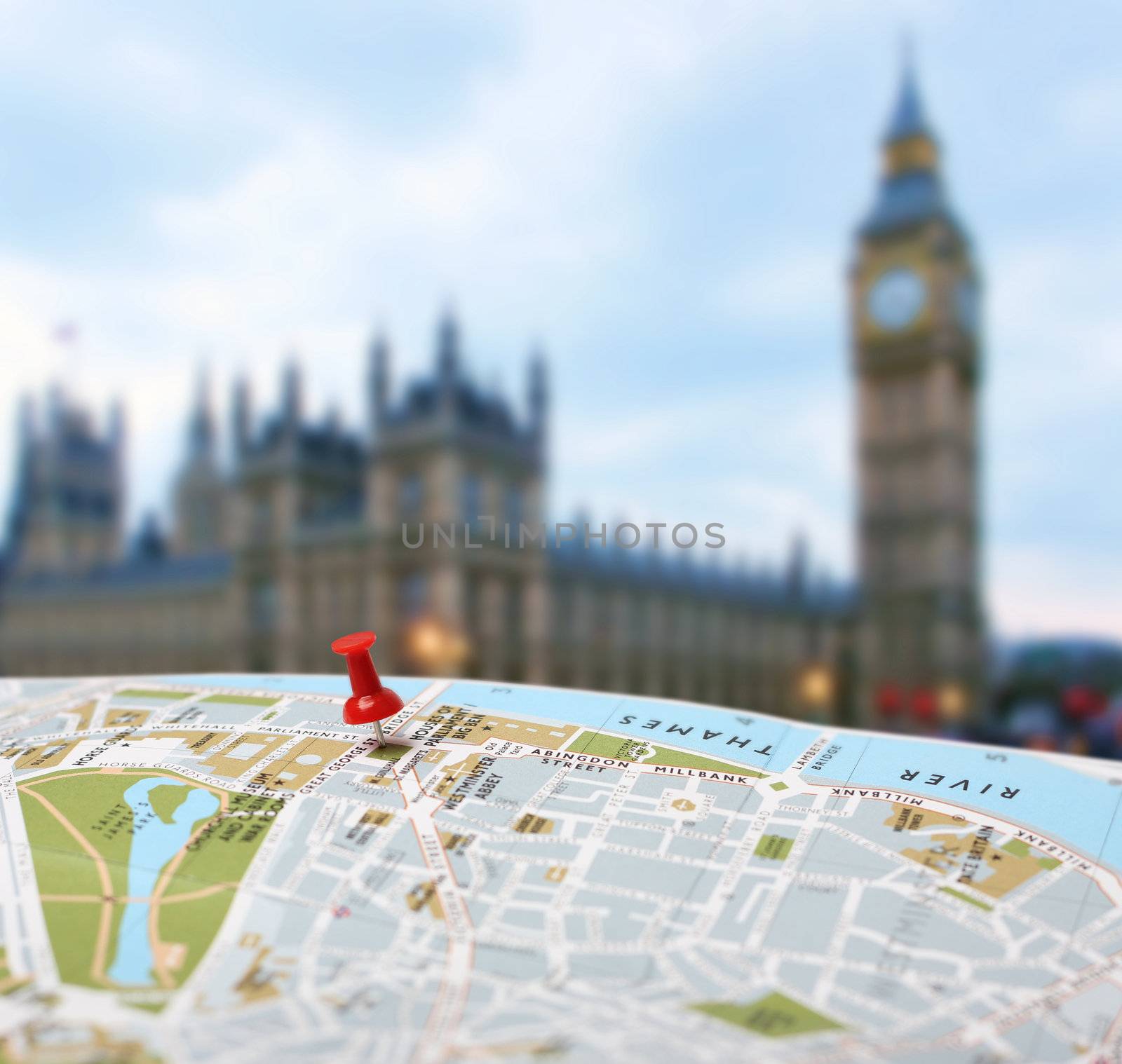 Red push pin pointing planned travel destination on London city map