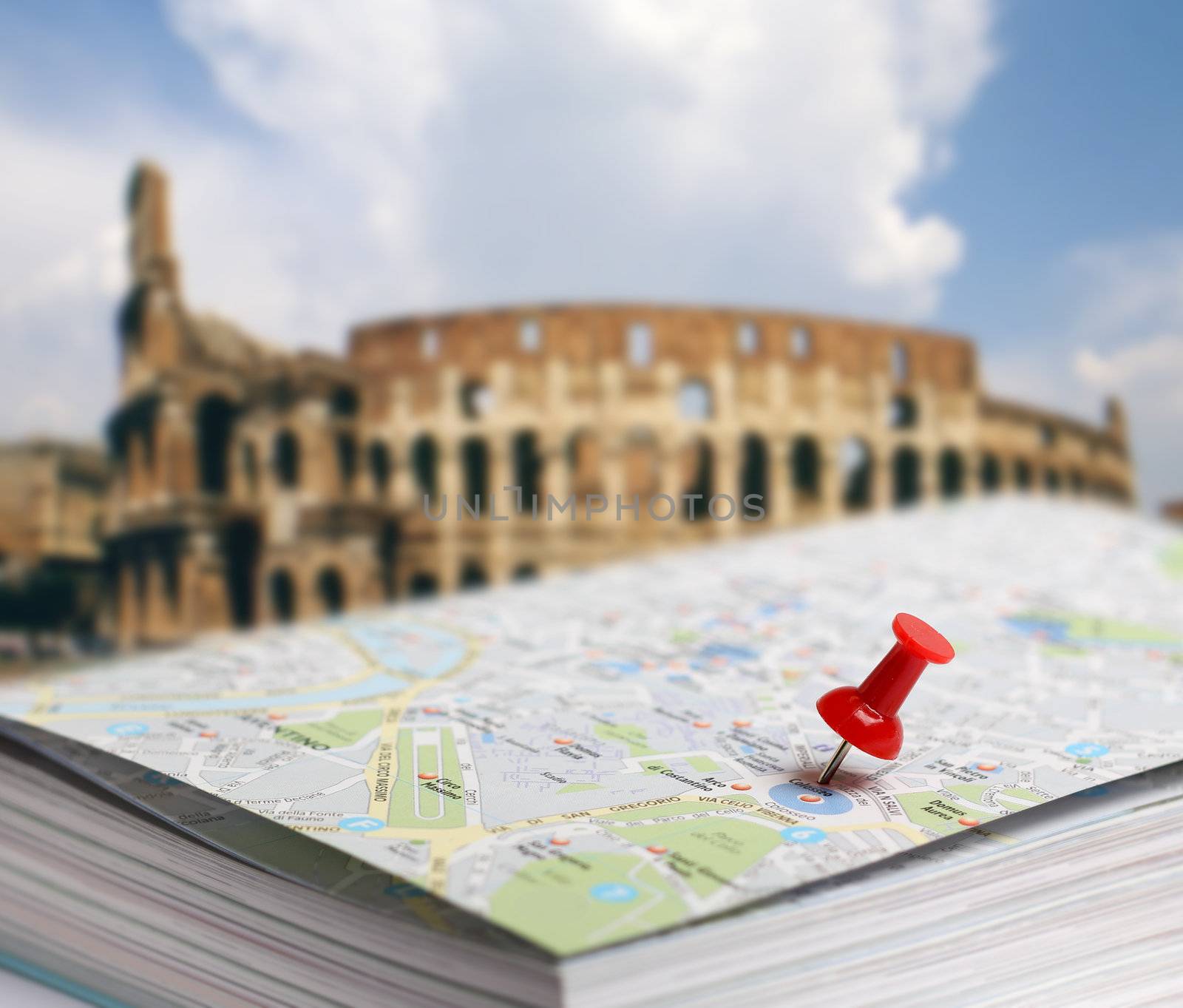 Red push pin pointing planned travel destination on Rome city map