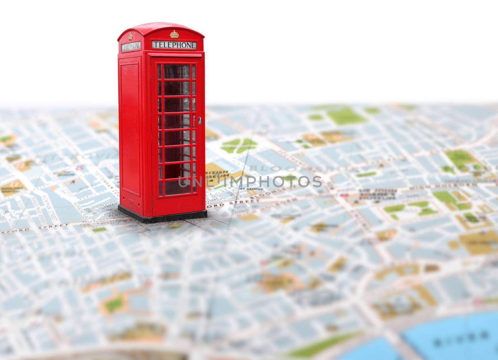 Red telephone booth pointing planned travel destination on map