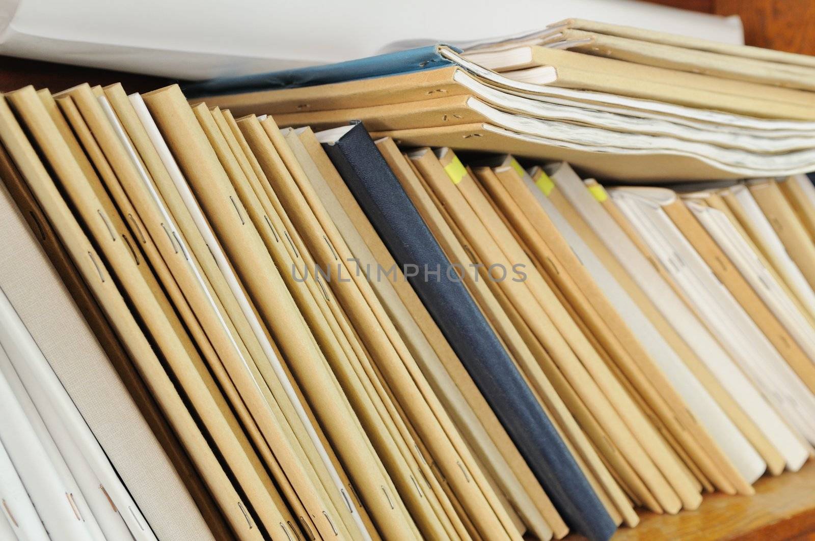Wooden shelf with file folders, archival documents.