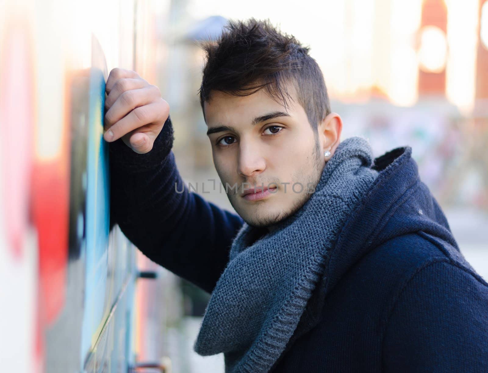 Portrait of attractive young man against colorful wall