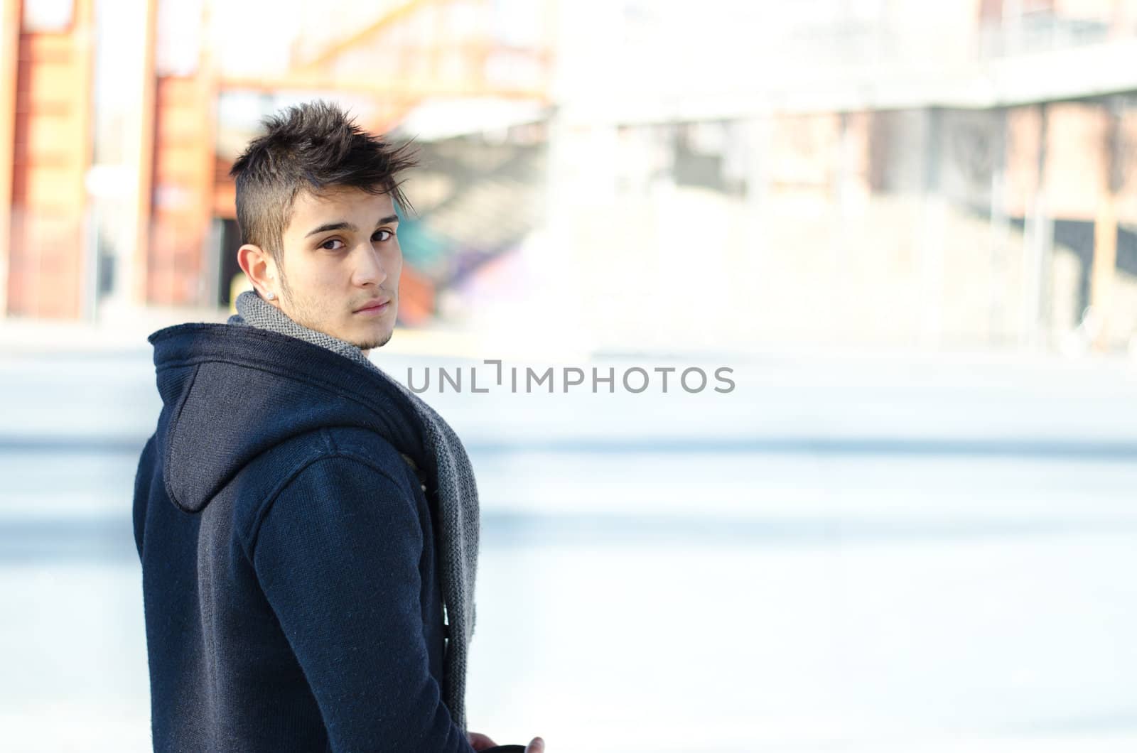 Handsome young man  in urban environment, large copy-space