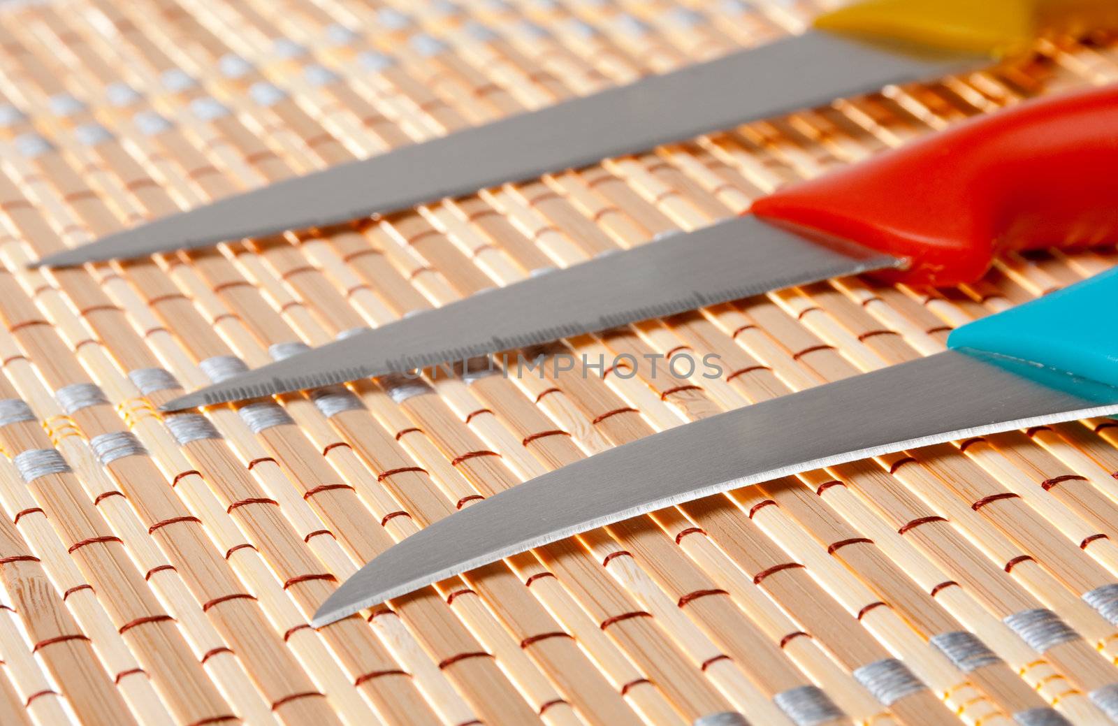 Set of kitchen knifes on bamboo napkin