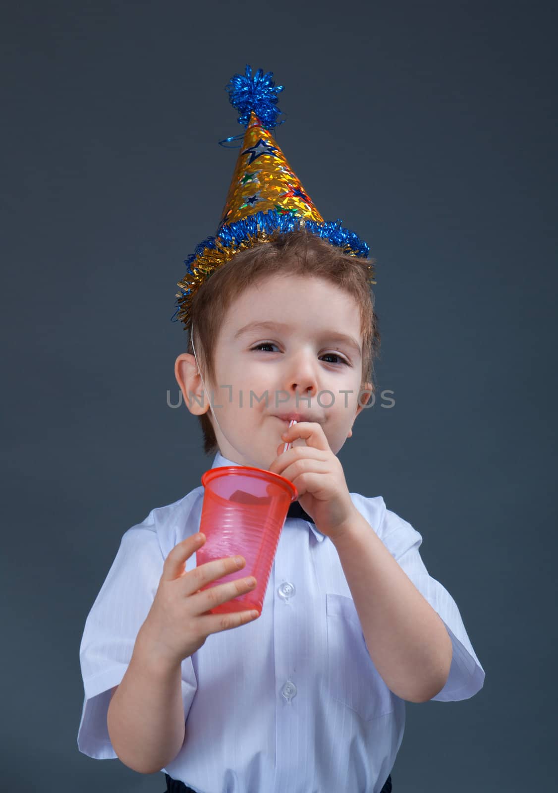 holiday Boy drinking juice isolated on white 