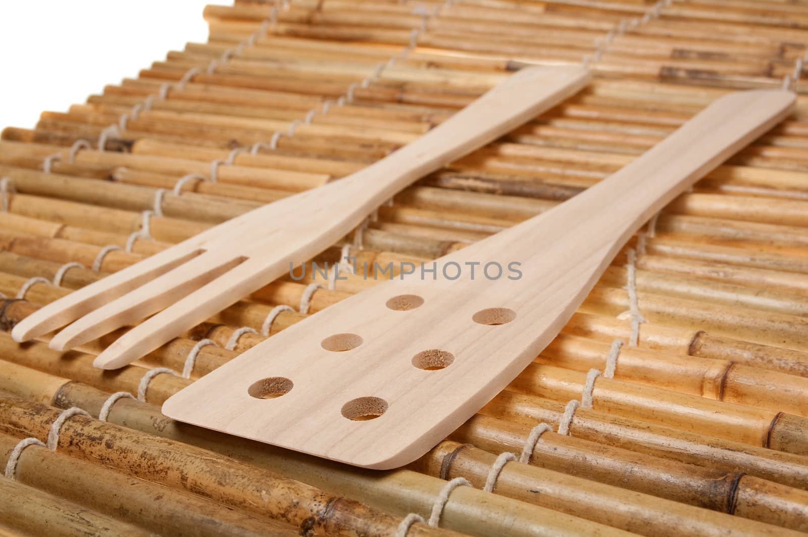 set of three wooden kitchenware on bamboo napkin