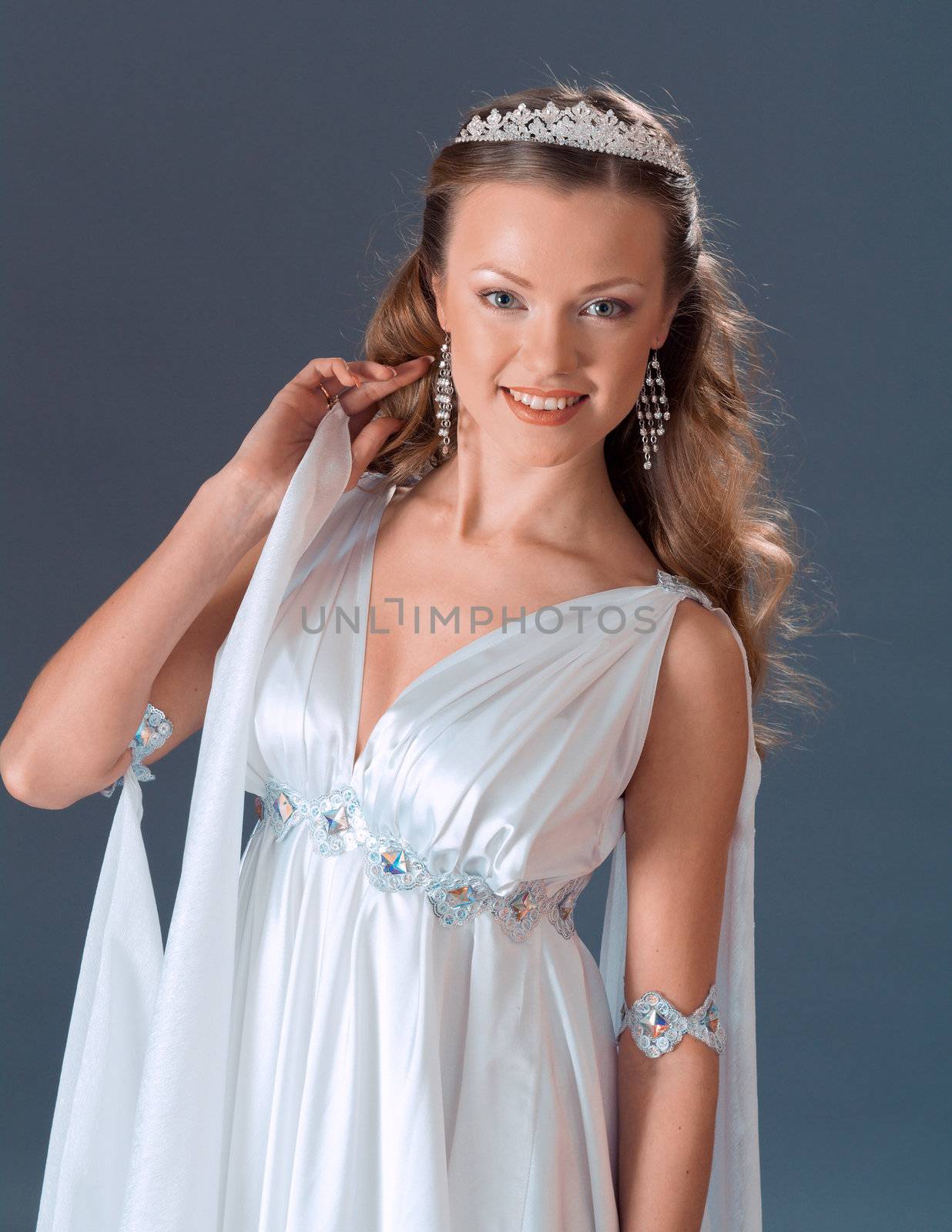 Beautiful young female wearing white dress in antique style  .Like goddess