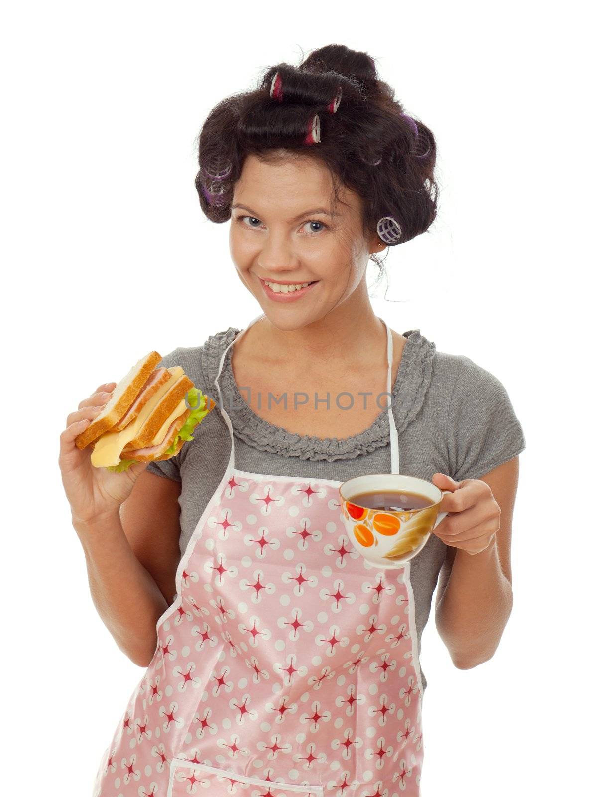 sexy housewife drinking tea with sandwich. Studio, white background. 