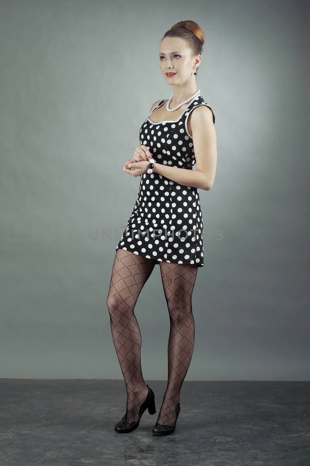 Girl in american 60s style in  polka dot dress 