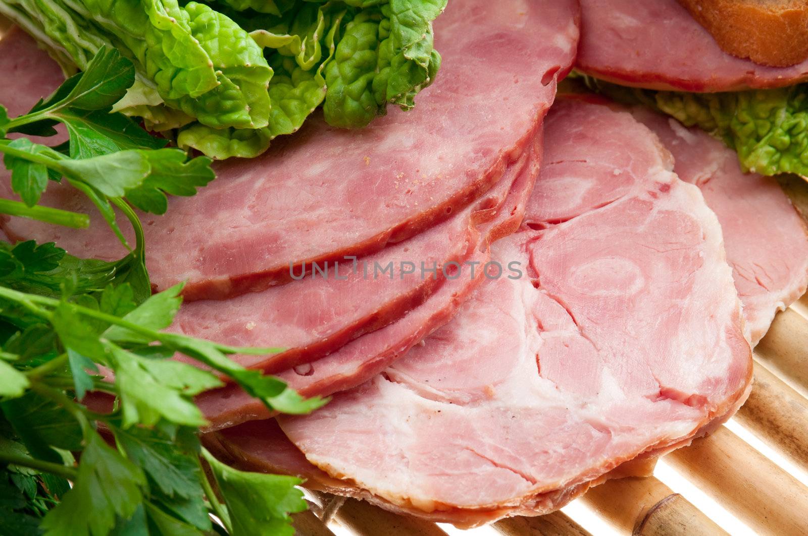 Beautiful sliced food arrangement of meat, bread and vegetables . bamboo napkin