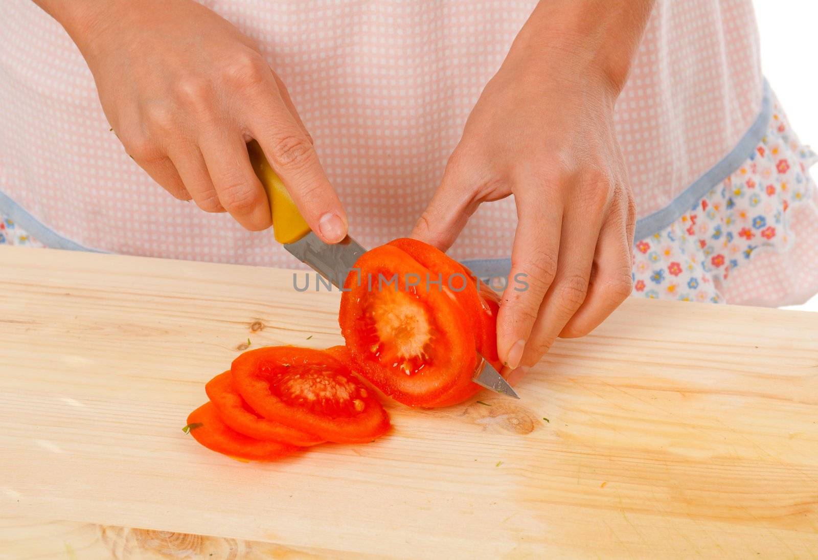 housewife preparing  tomato .Studio, white background. 