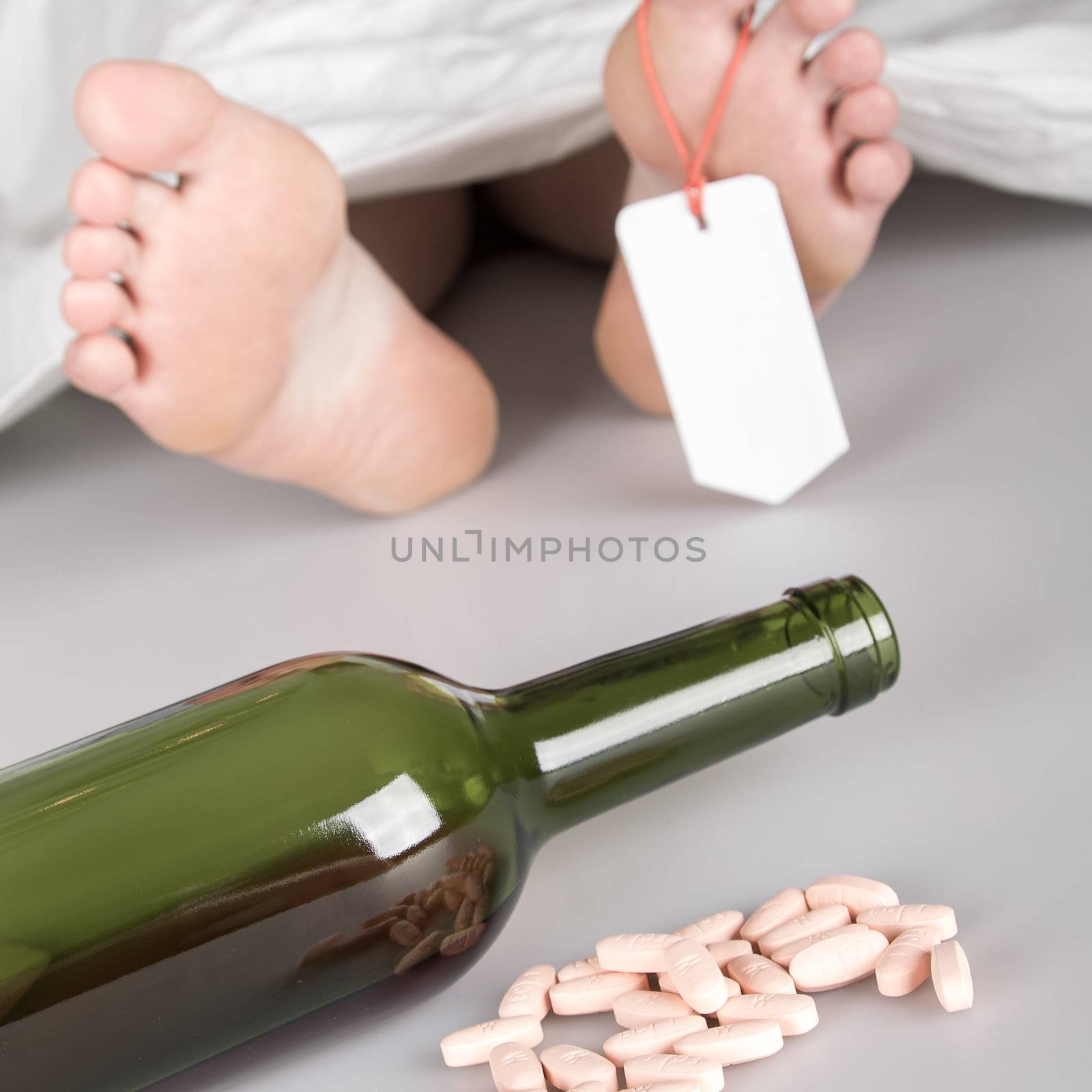 Dead body with toe tag, suicide by drug overdose and alcohol