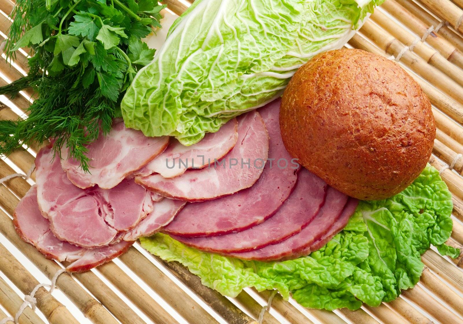 Beautiful sliced food arrangement of meat, bread and vegetables . bamboo napkin