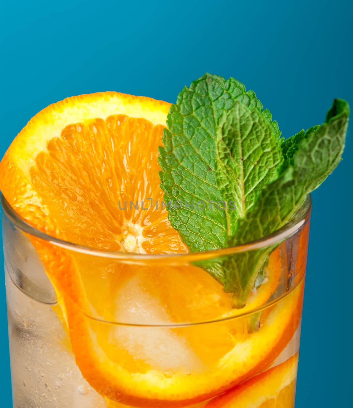 Mojito orange cocktail.on blue background. close up