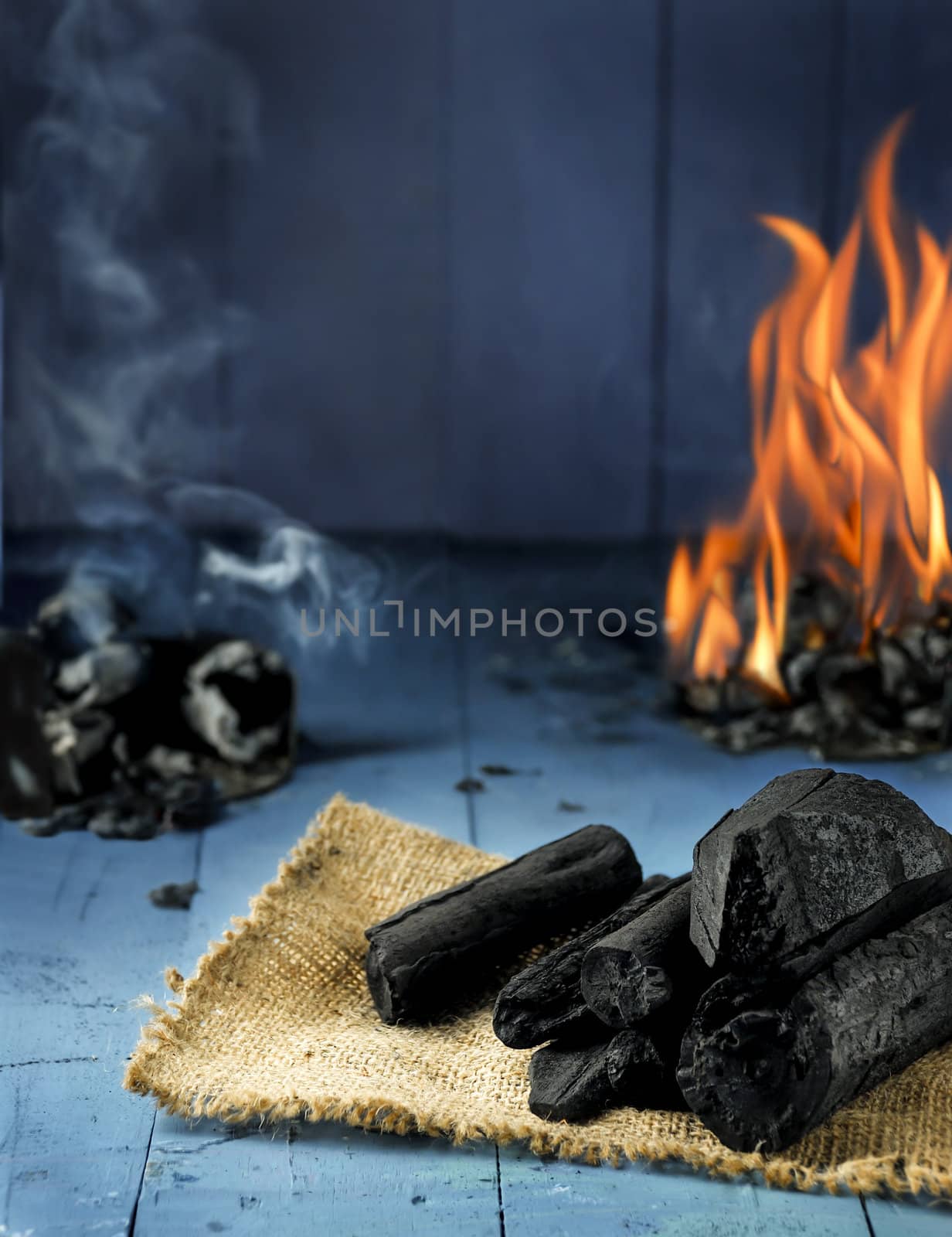 charcoal fire smoke on blue wood