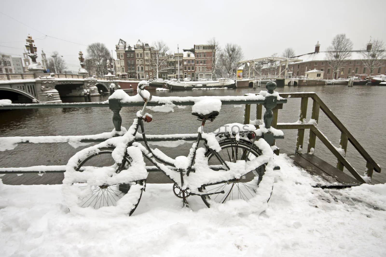 Snowy bicycle in Amsterdam city center the Netherlands by devy