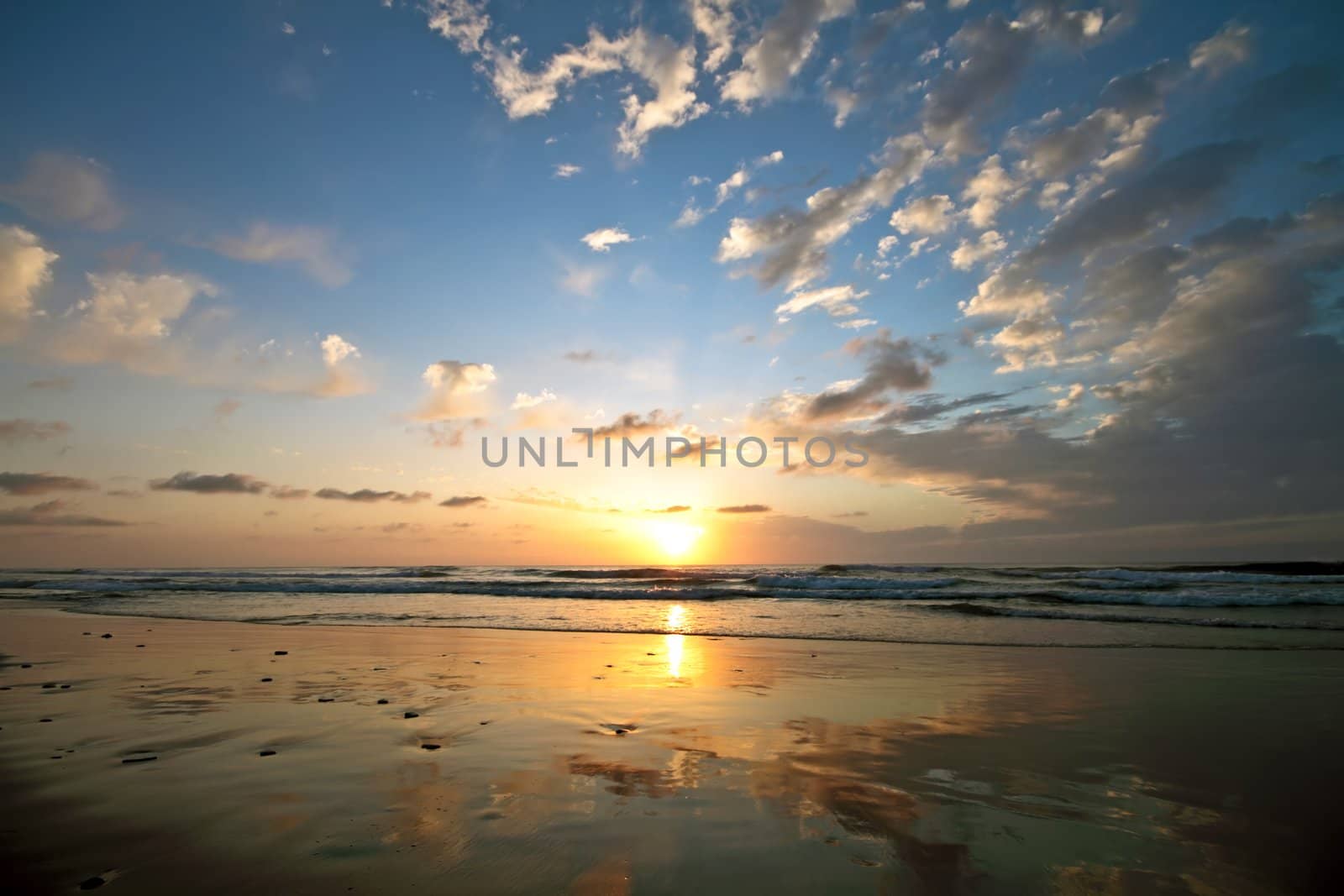 Beautiful cloudscape at the beach at sunset