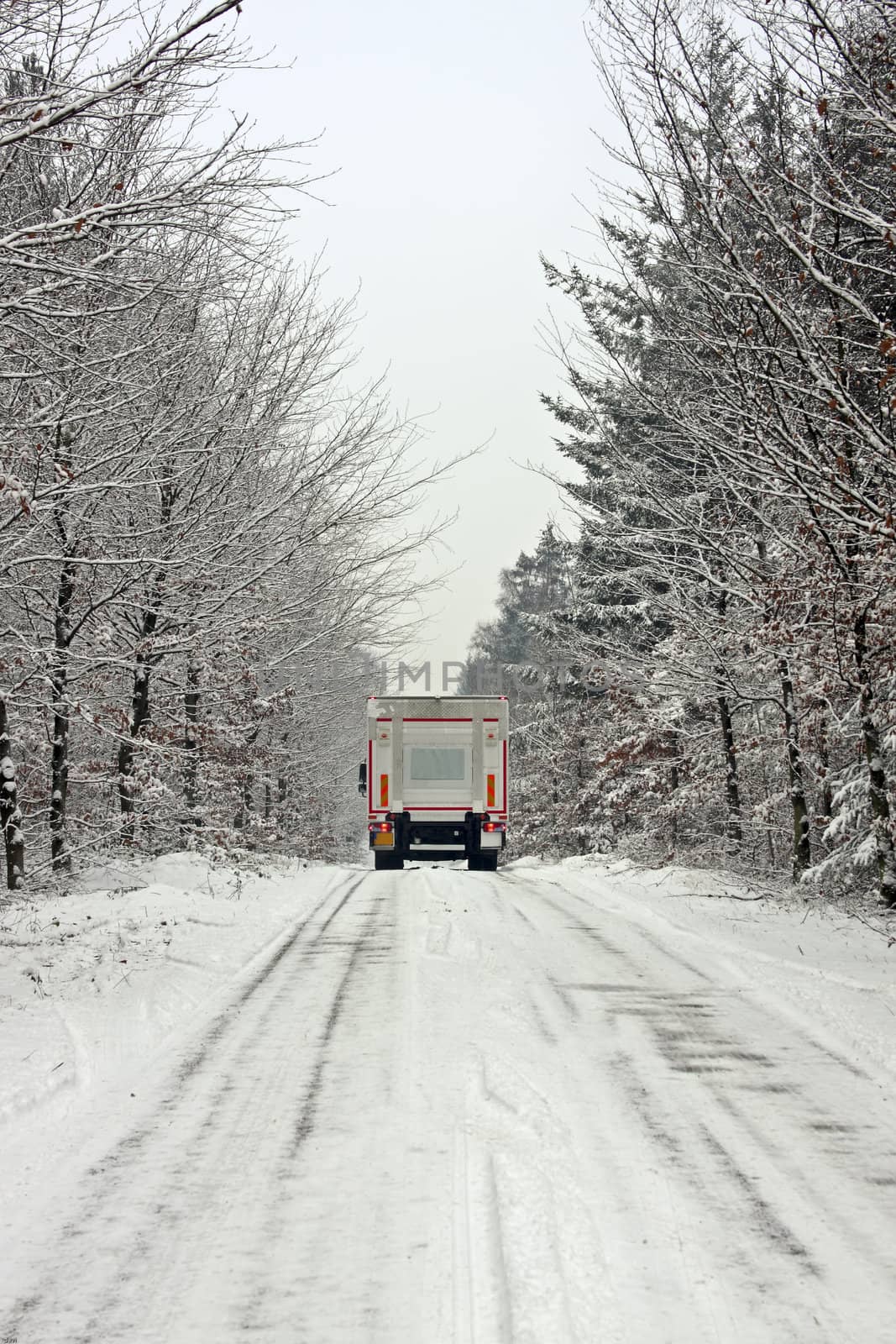 Truck driving in the snow in the countryside from the Netherland by devy