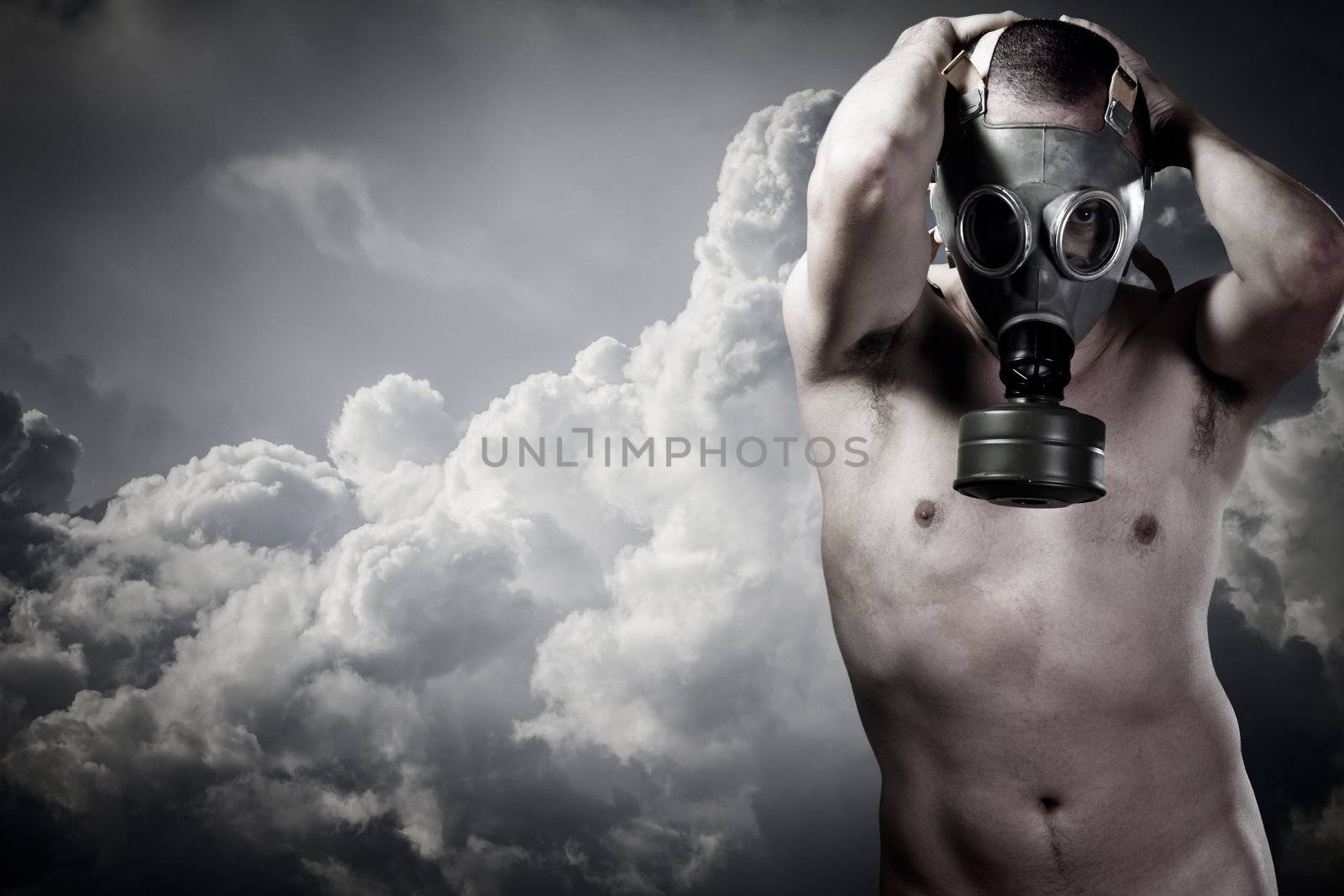 pollution concept: portrait of nude man in a gas mask