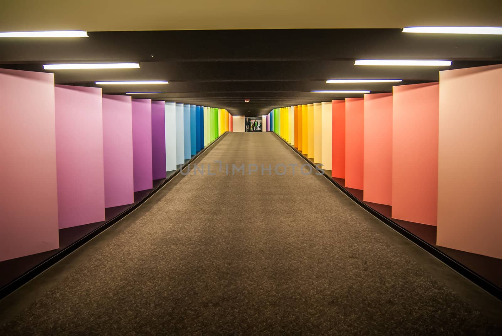 vanishing point of rainbow colored corridor at certain mall