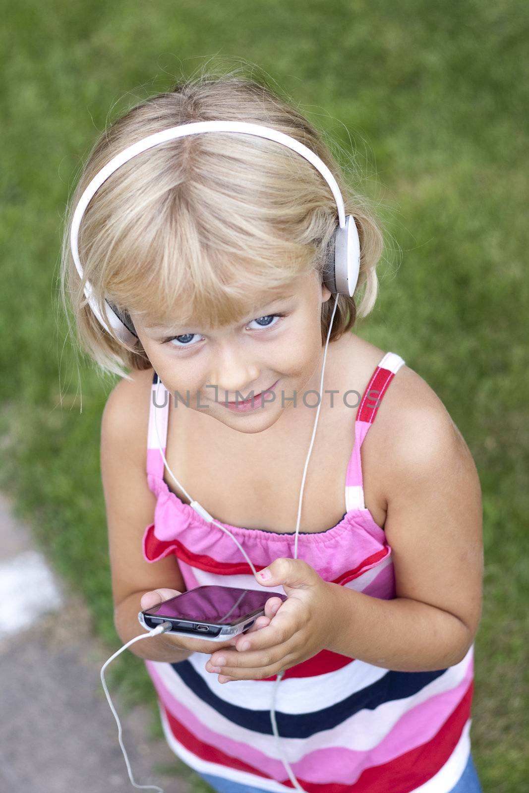 Child with smartphone and headphones by annems