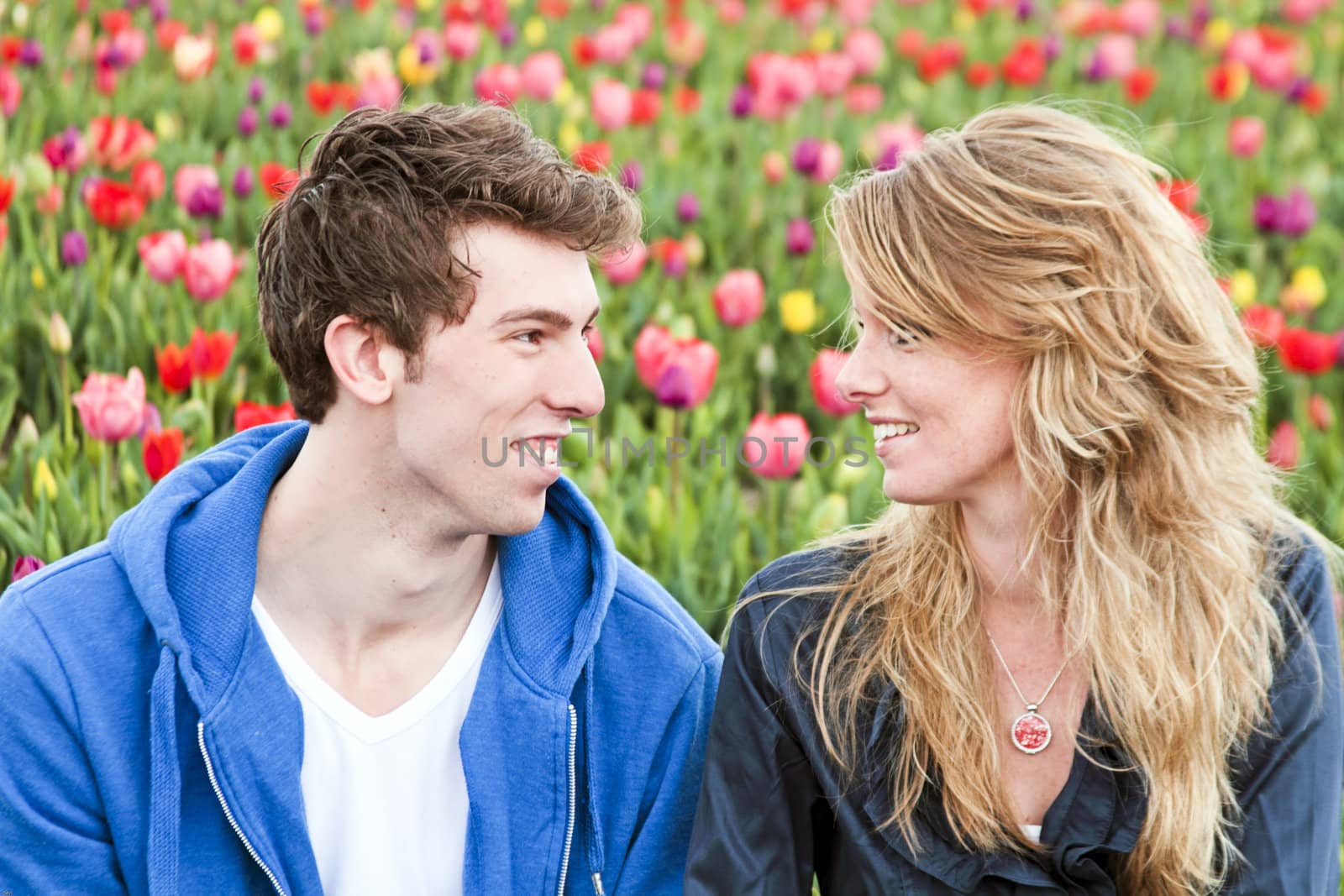 Young happy couple in the tulipfields from the Netherlands