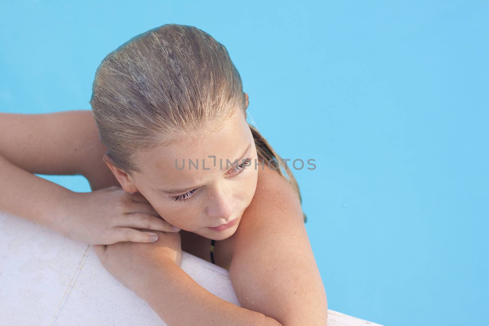 A child relaxing in a swimming pool, Space for text