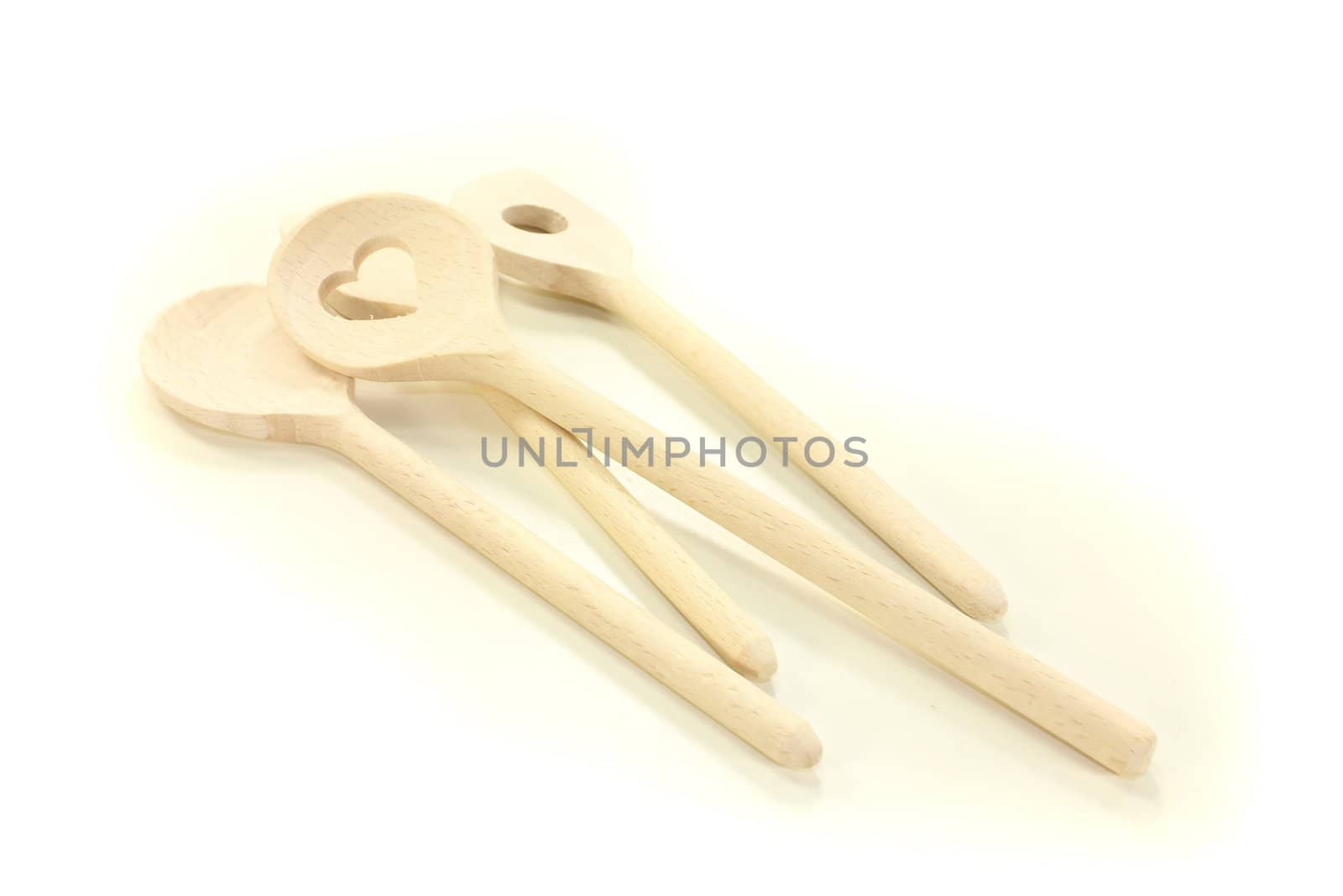 four wooden cooking spoon on a bright background