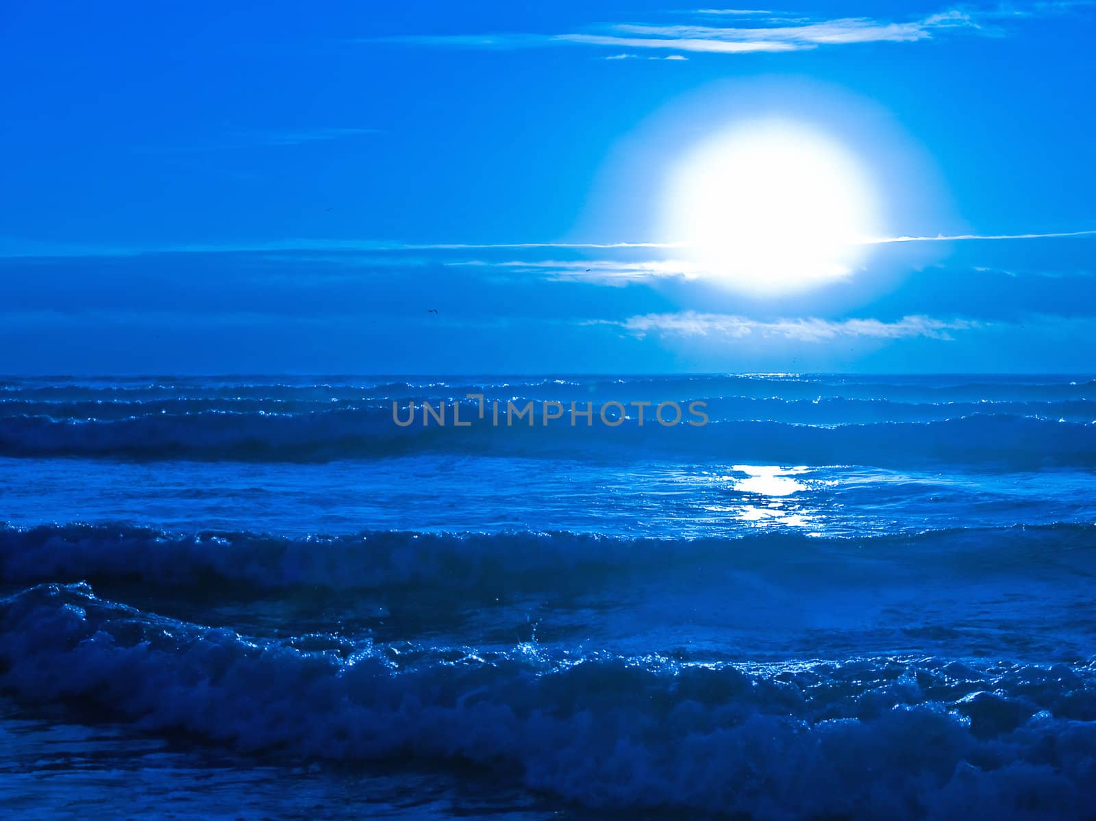 Blue Sunset Over the Ocean with Waves in the Foreground by Frankljunior