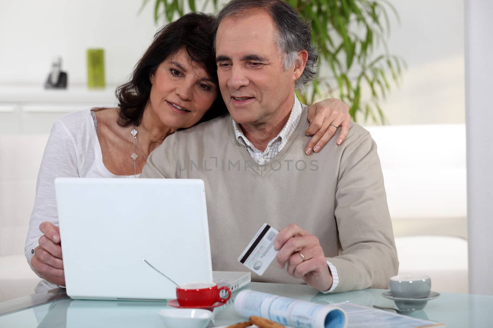 Middle-aged couple shopping on-line by phovoir