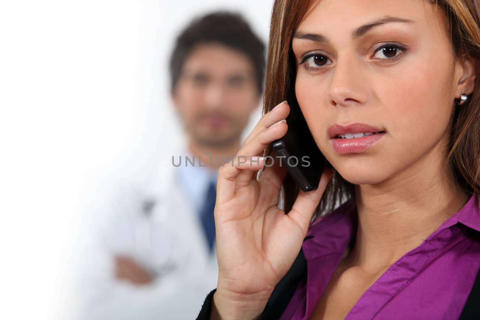 Businesswoman using a cellphone by phovoir