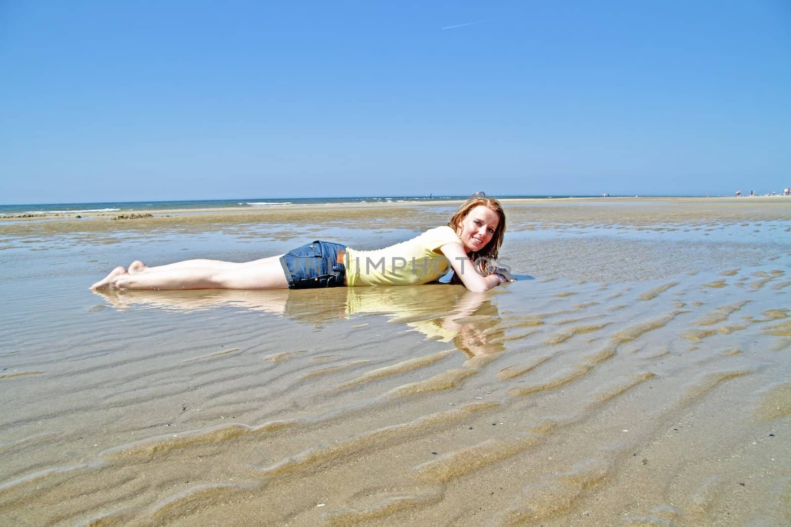 Young blonde woman lying in the water from the north sea