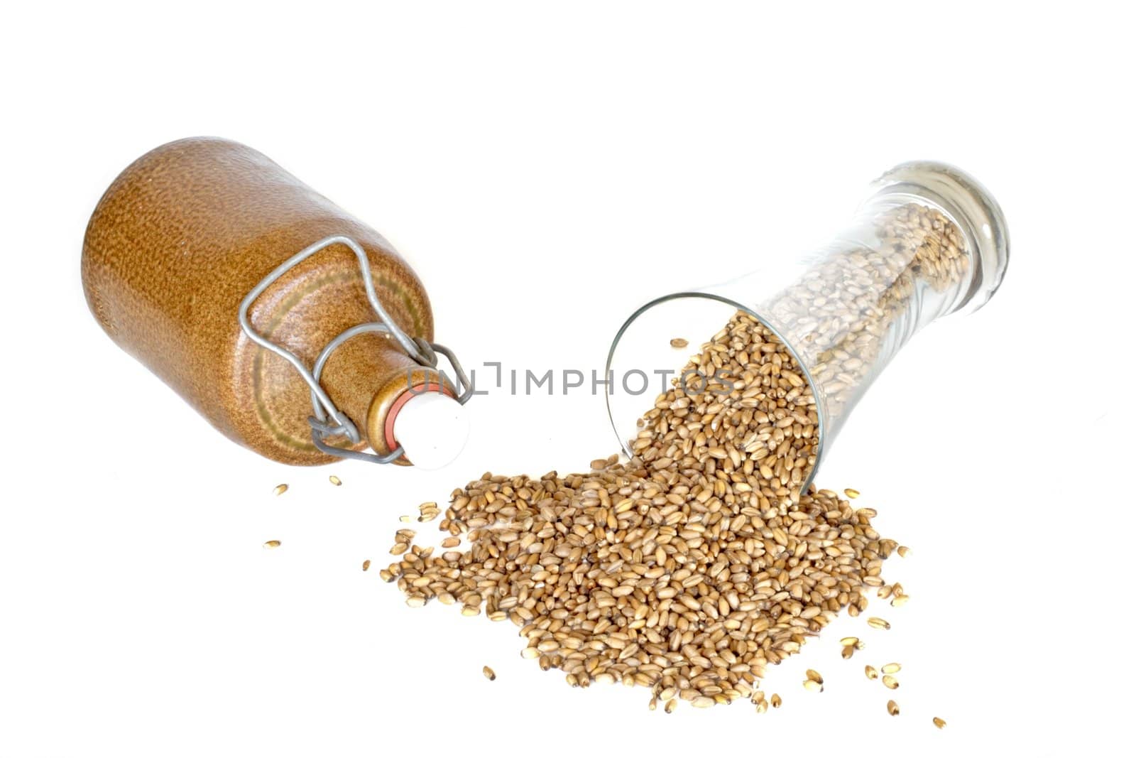 Glass of beer with grain on a white background