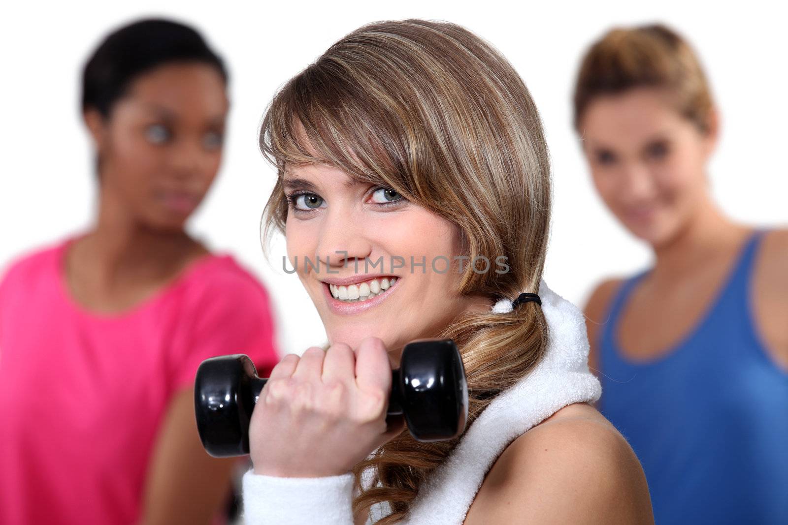 Pretty girl lifting a dumbbell by phovoir