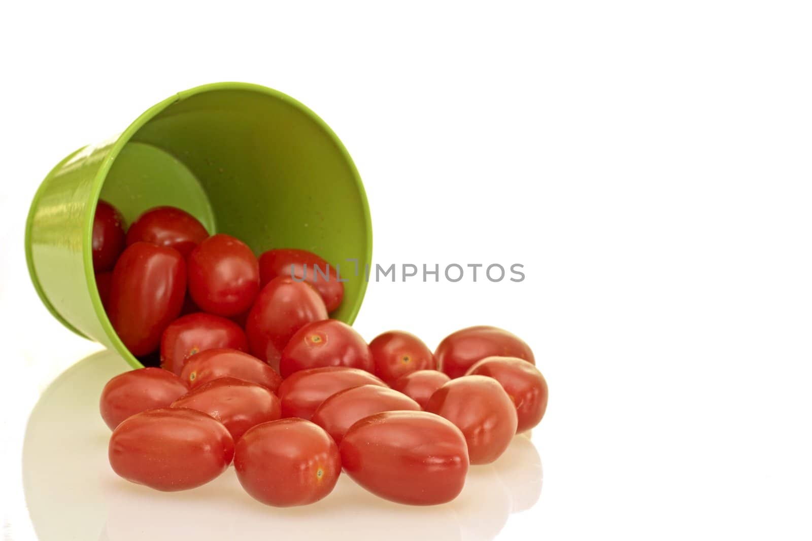 Green bucket full of tomatoes