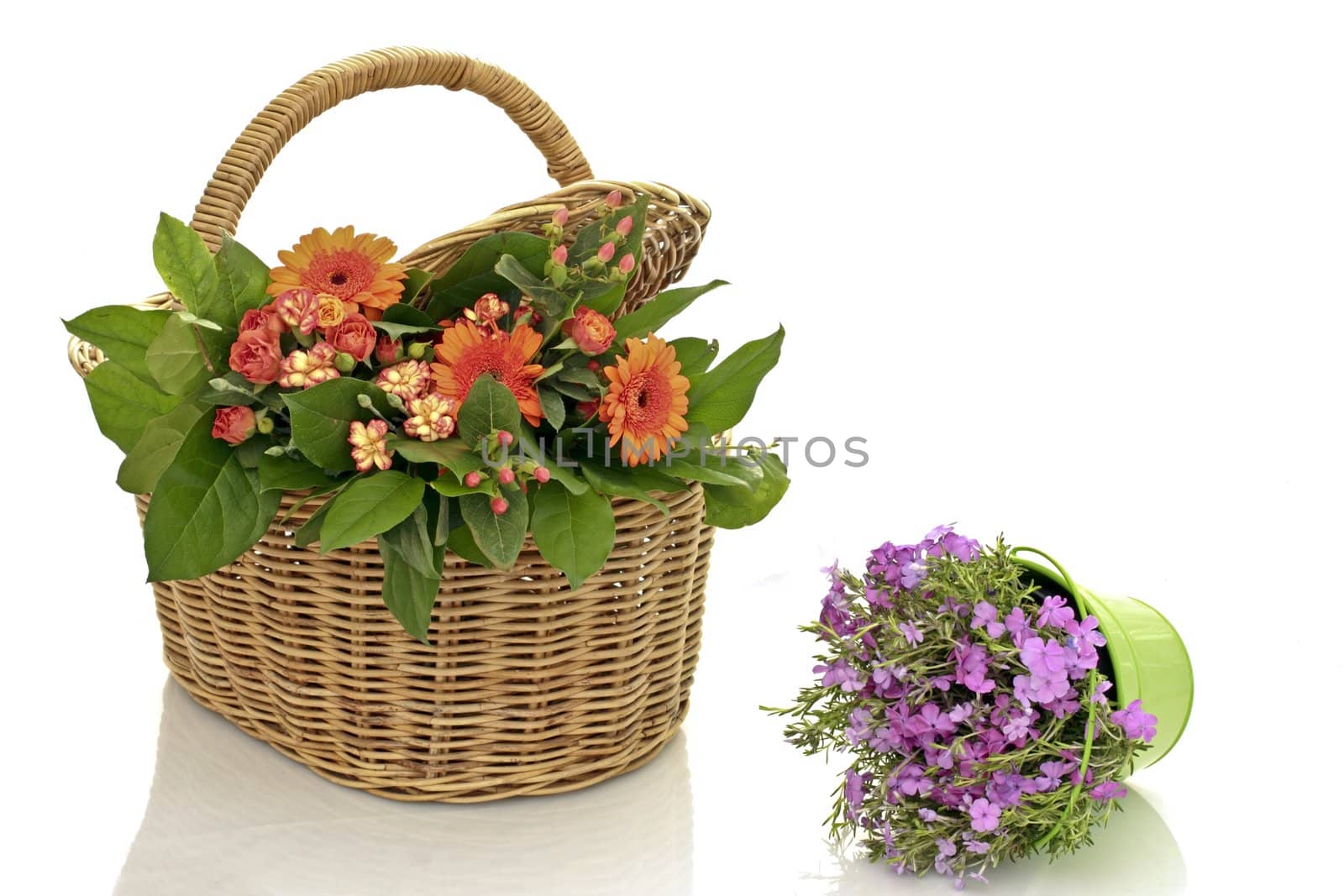 bouquet of flowers in a wicker basket on a white background