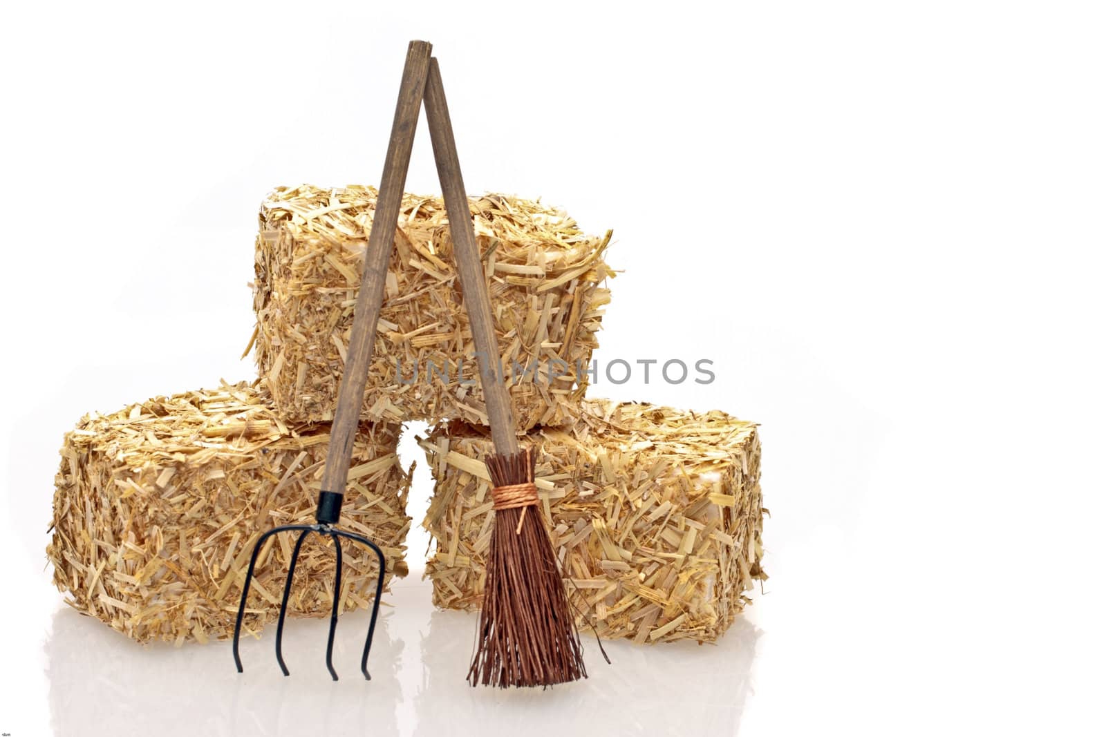 Hay bales with tools on a white background