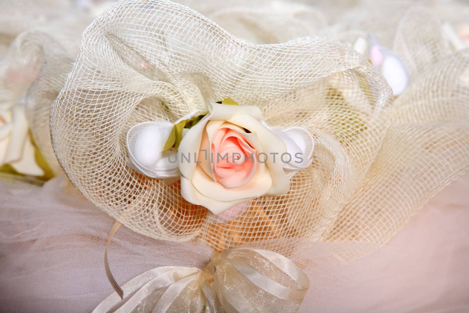 close up of christening favor with rose and veil
