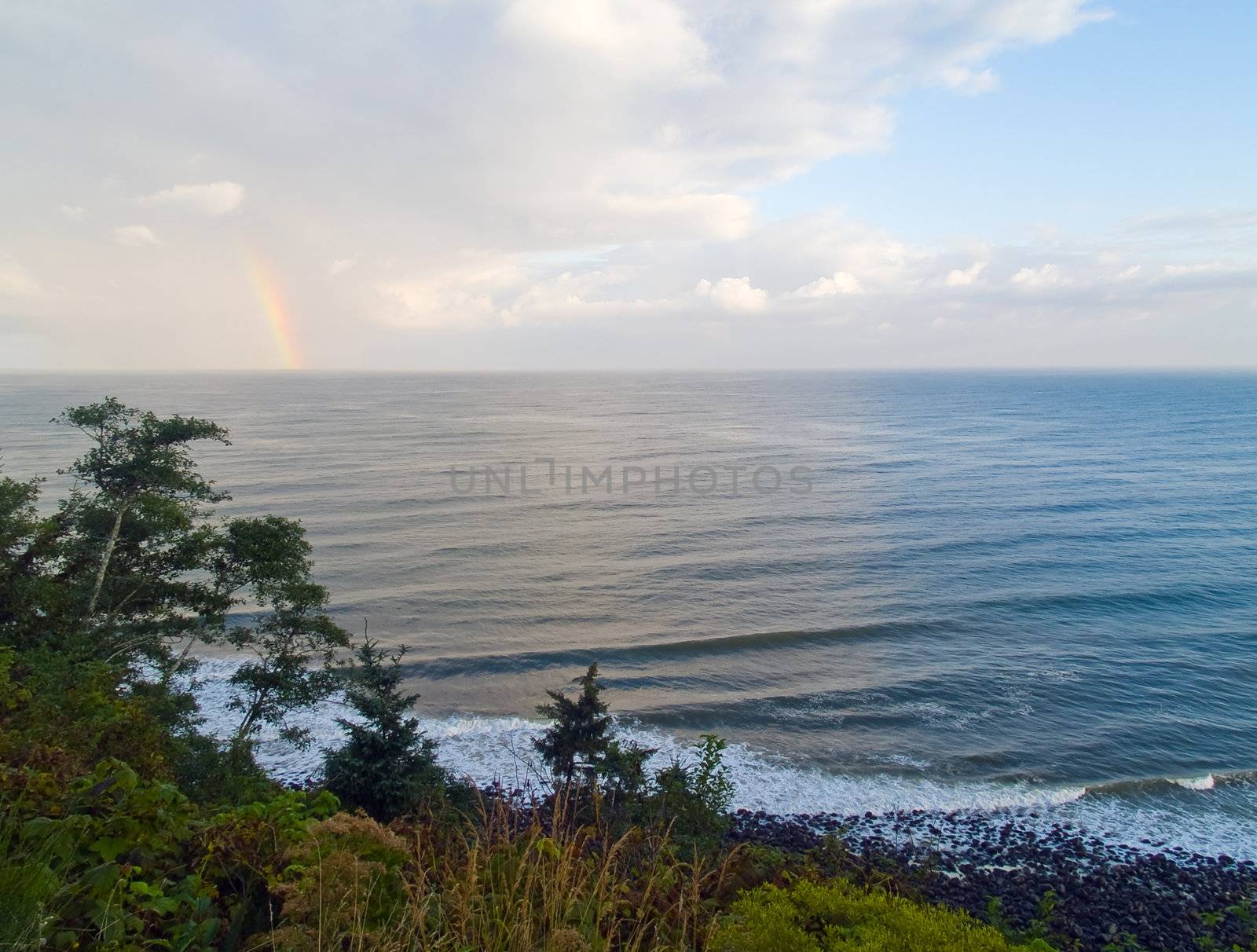 Rainbow Over the Ocean with a Partly Cloudy Sky by Frankljunior