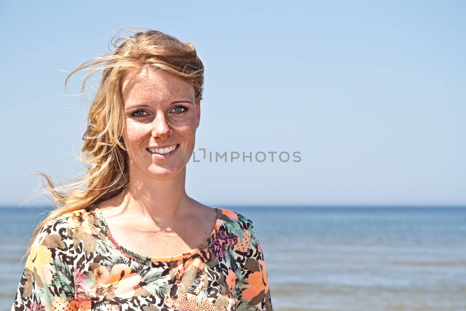 Beautiful young blonde woman at the beach