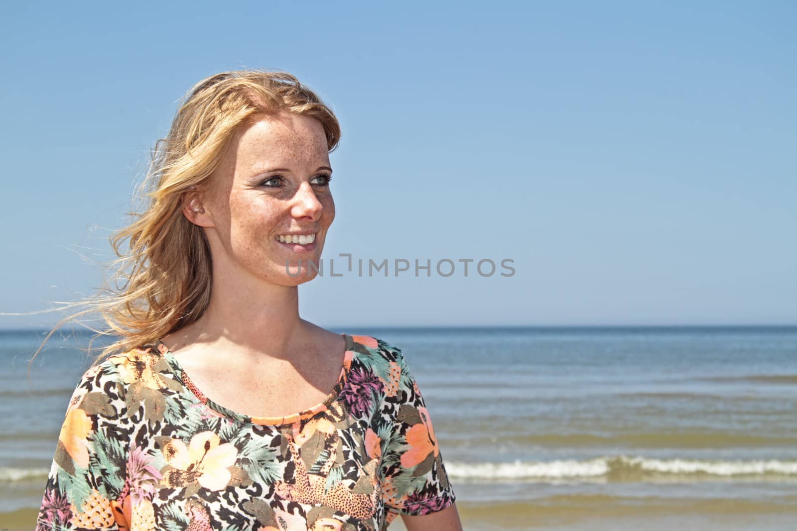 Beautiful young blonde woman at the beach